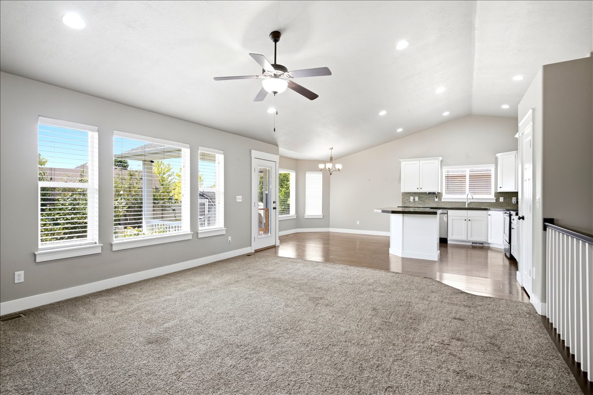 Vaulted ceilings and recessed lighting illuminate an open concept living space