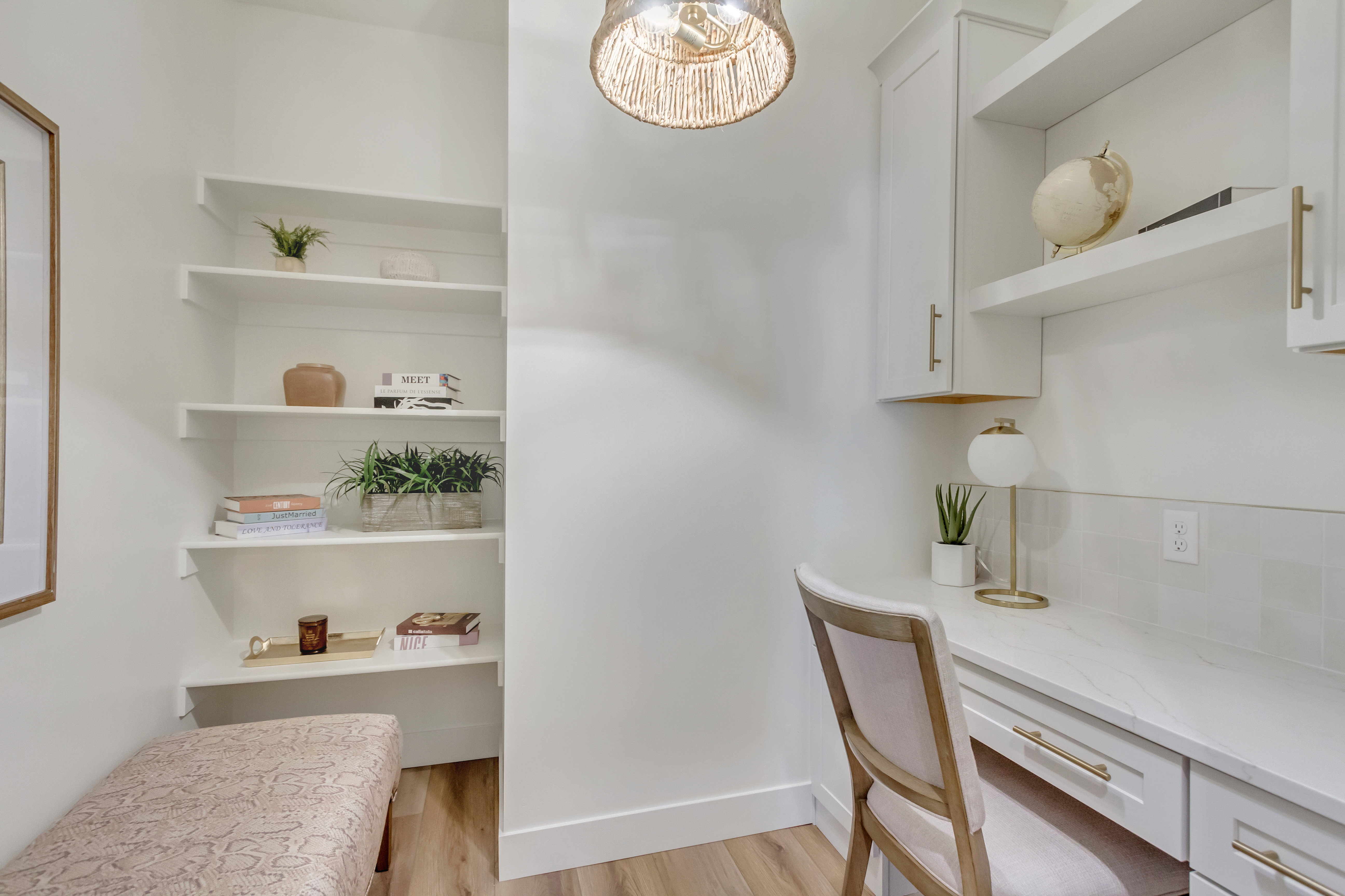 Dedicated workspace featuring a built-in desk with a white countertop and drawers