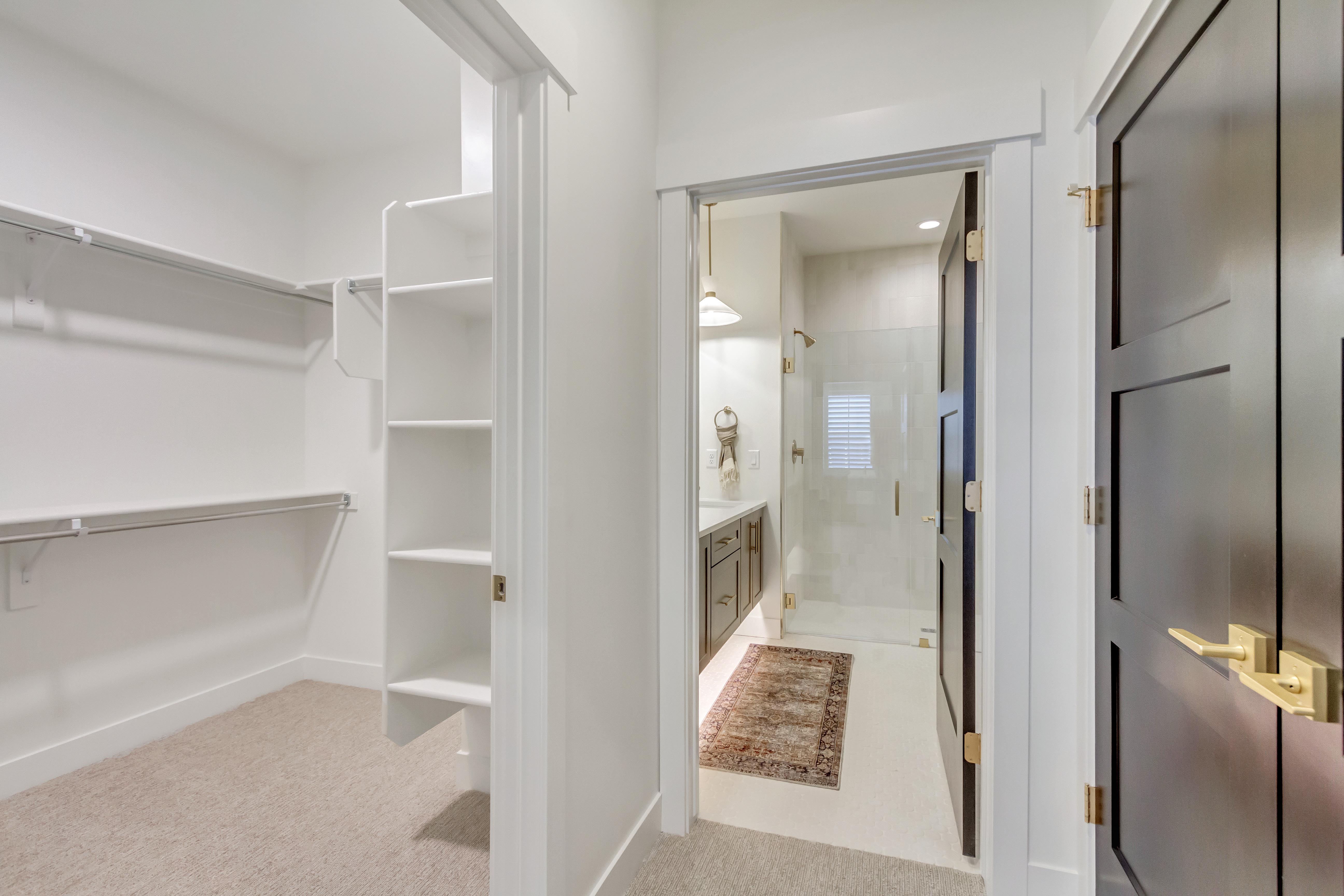 Walk-in closet featuring built-in shelving and hanging rods