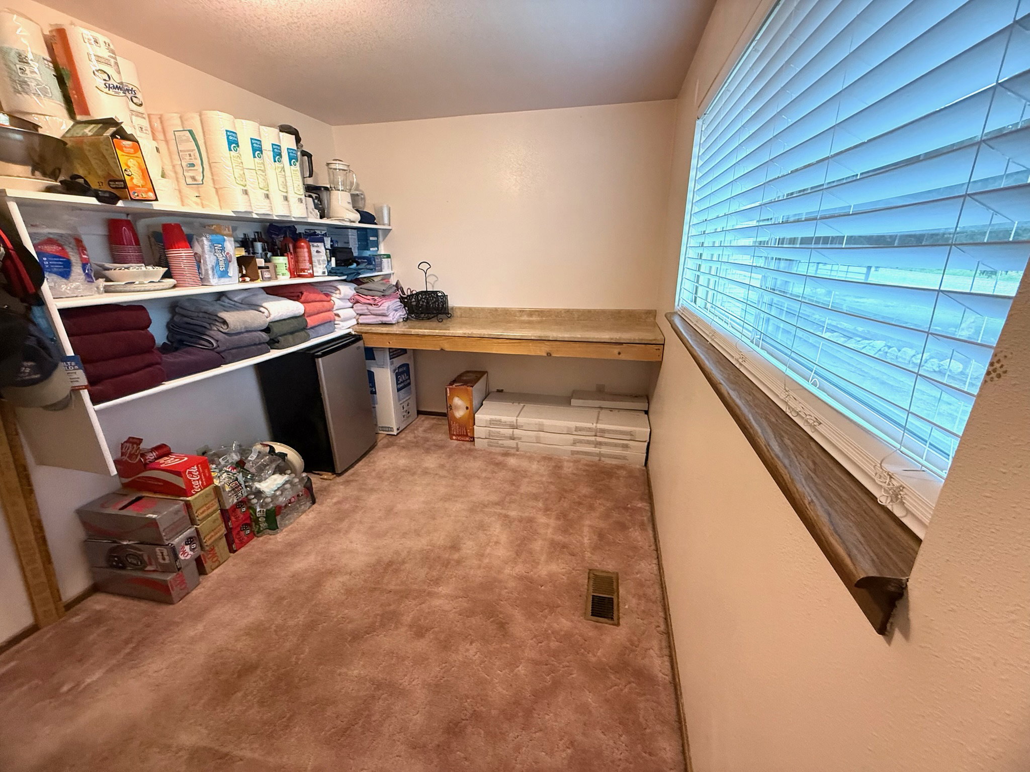 Built-in shelving and an extensive countertop provide generous storage and utility space