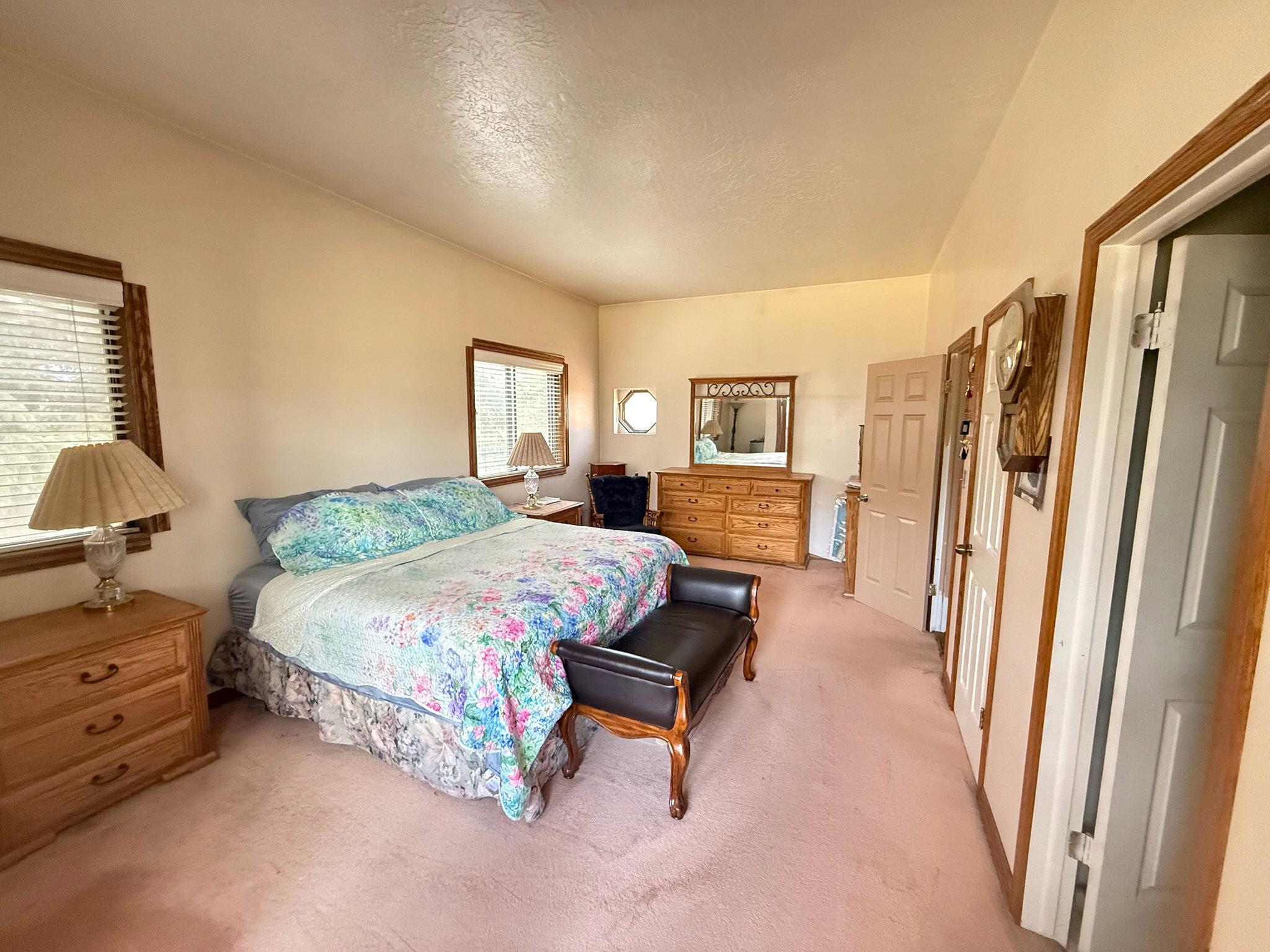 Spacious room featuring neutral wall paint and plush carpeting