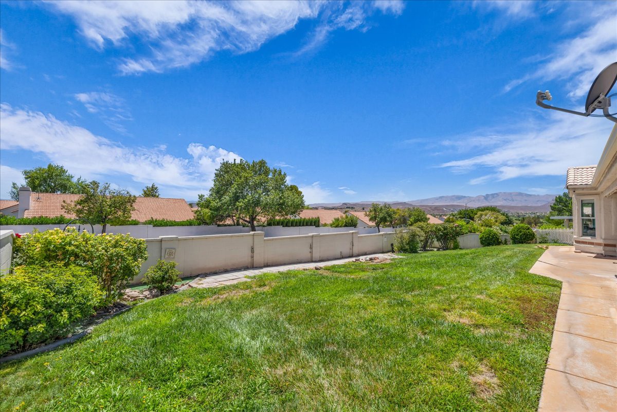 Expansive green lawn with mountain backdrop