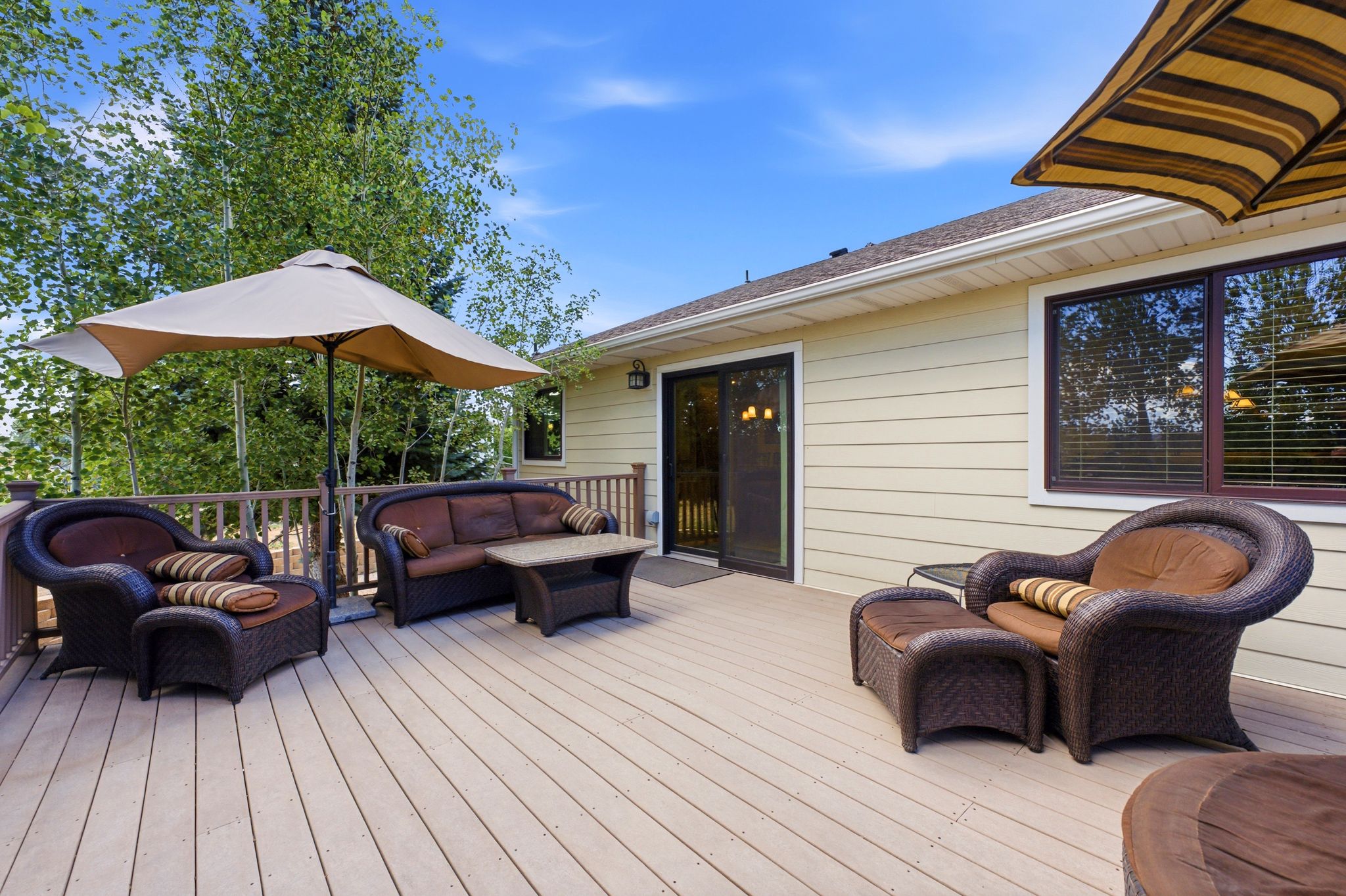 Expansive outdoor deck featuring wood-finish flooring and a wood railing