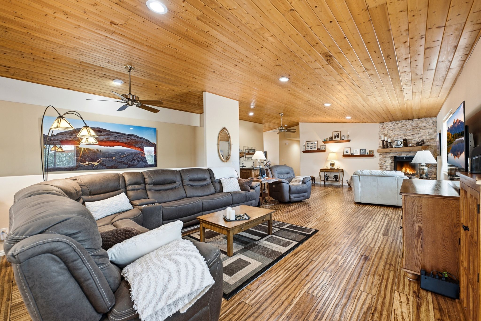 Spacious living area featuring wood-finish flooring and a wood plank ceiling