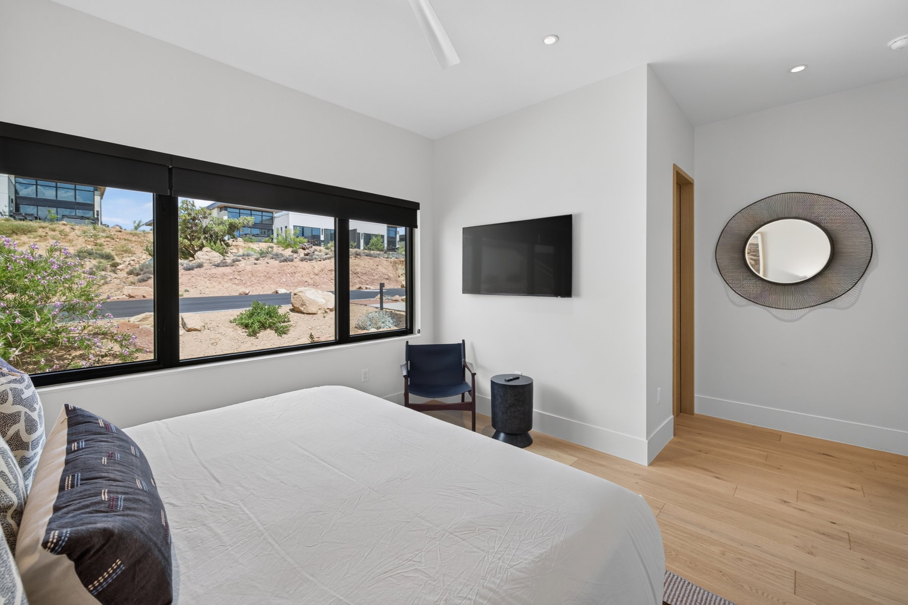 Spacious room featuring light wood-finish flooring, white walls, and recessed lighting