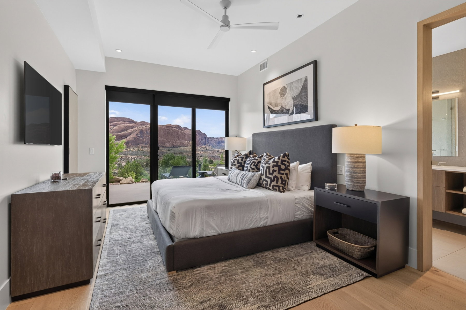 Spacious room featuring floor-to-ceiling sliding glass doors, light wood-finish flooring, a contemporary ceiling fan, and recessed lighting