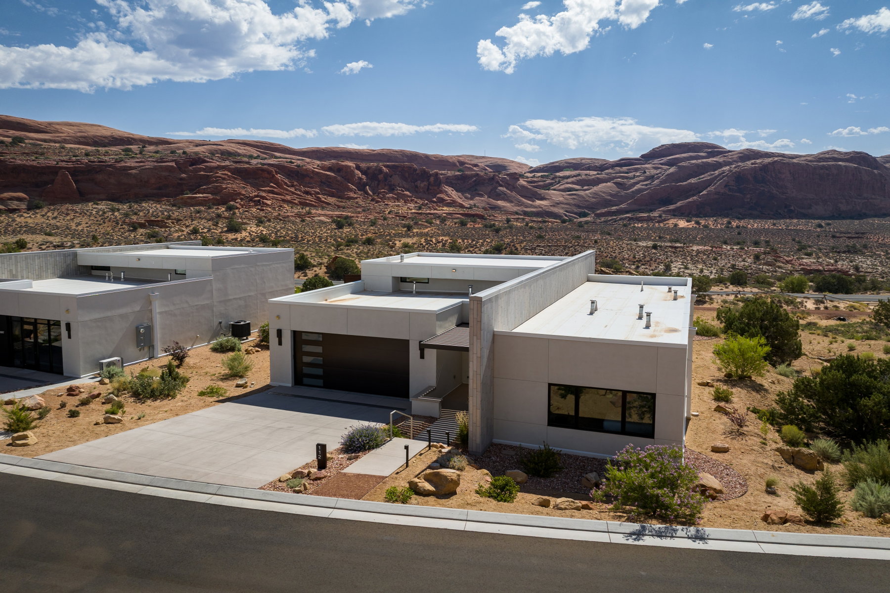Modern desert architecture featuring a flat roofline and integrated garage