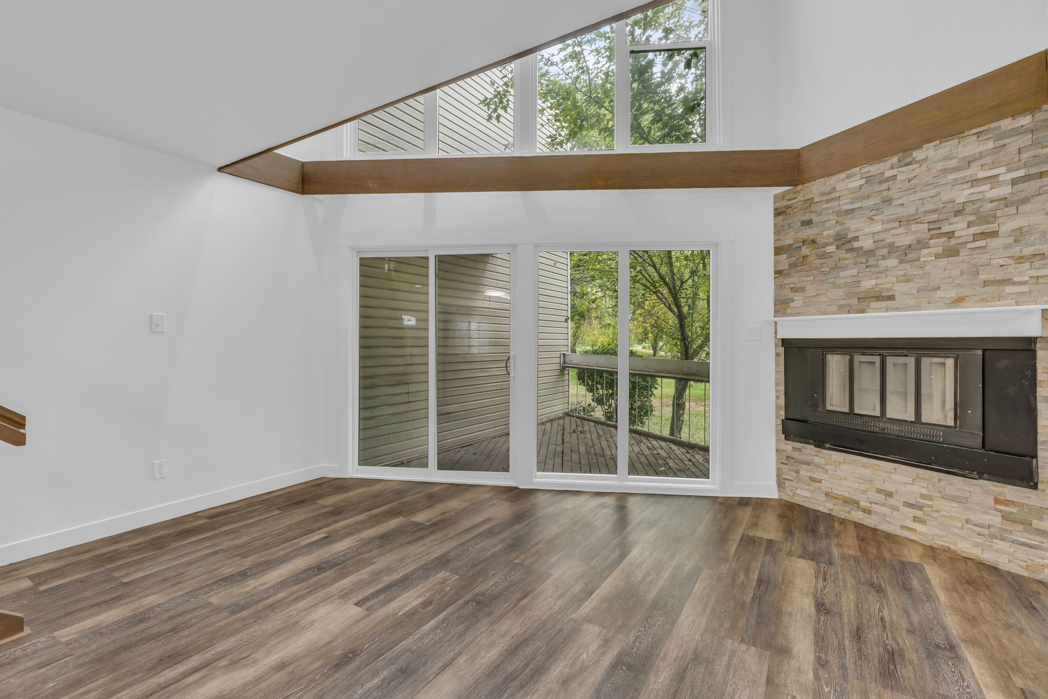 Corner fireplace with stone surround and white mantel