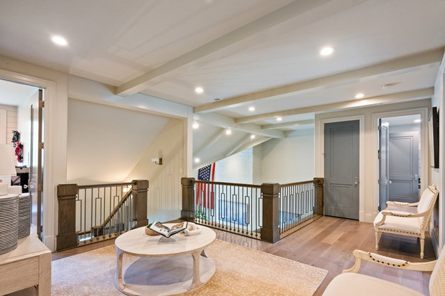 Upper-level landing featuring wood-finish flooring, recessed lighting, and exposed ceiling beams