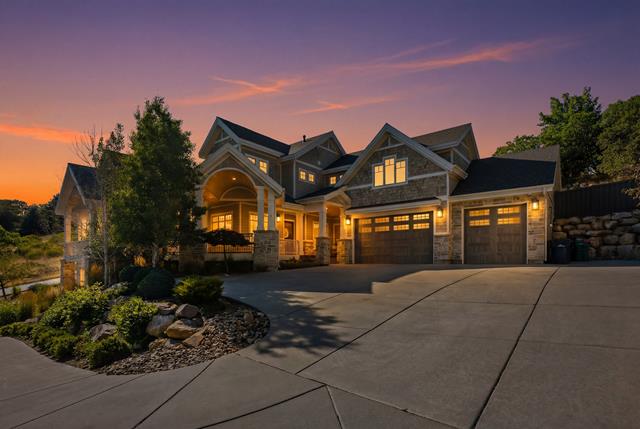 Stone and siding exterior with multiple gables and a covered front entry
