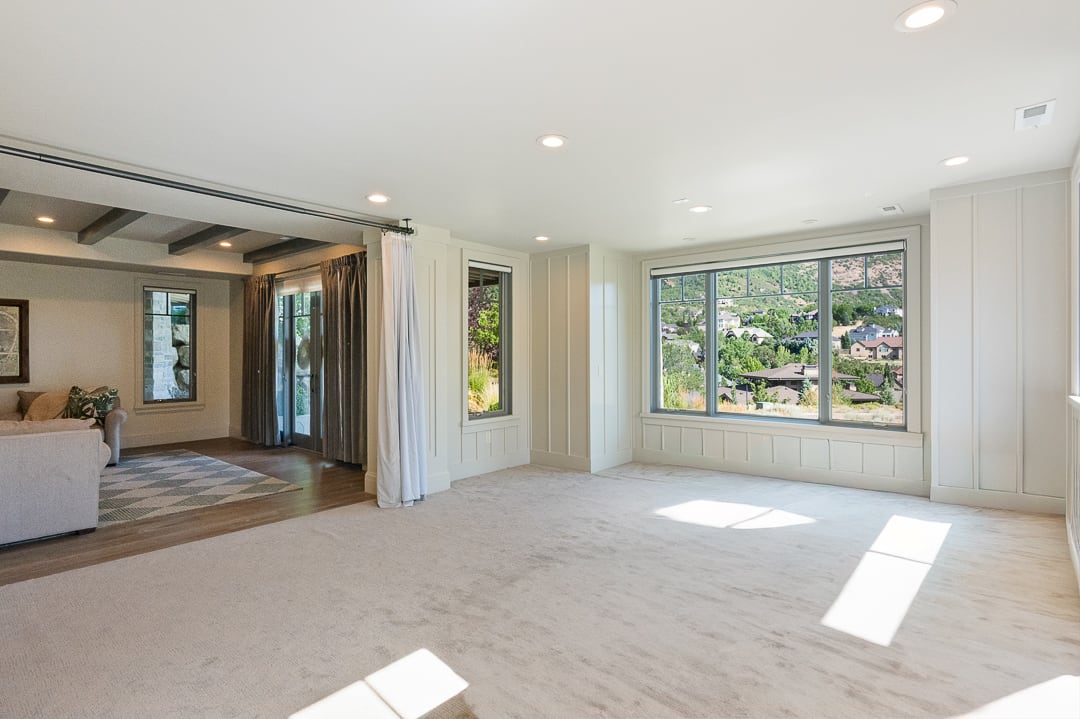 Spacious room featuring broadloom carpeting and multiple large windows