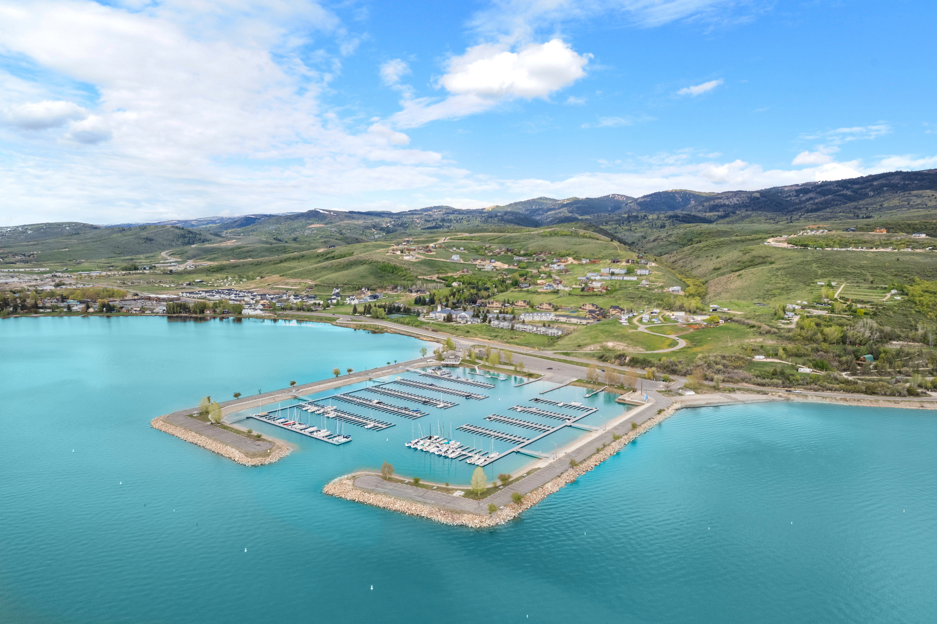 Expansive marina with numerous boat slips on a turquoise lake
