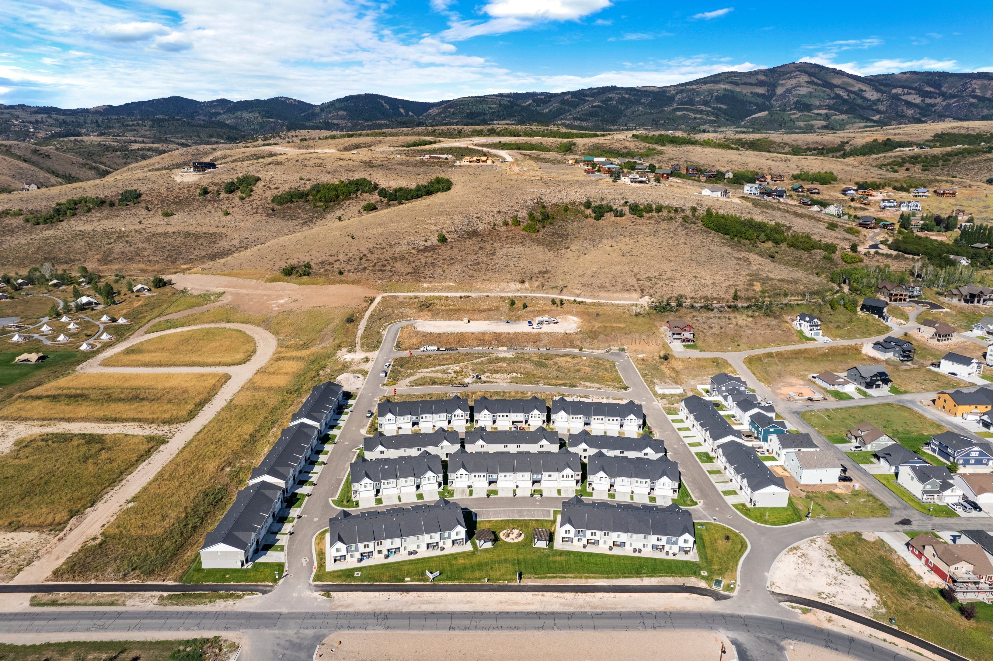 Expansive aerial perspective showcasing a residential community with numerous newly constructed homes