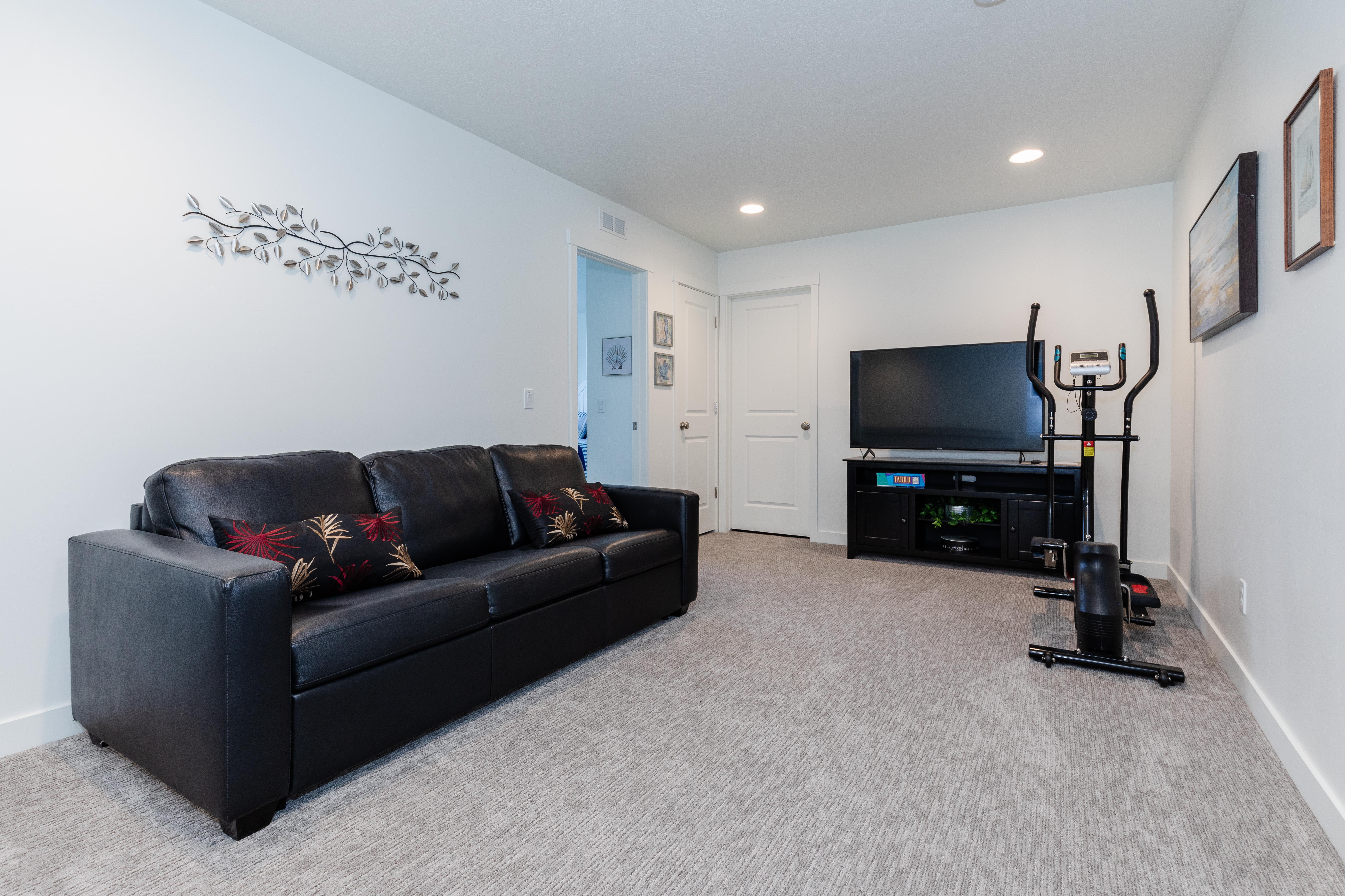 Spacious room featuring light gray patterned carpeting, white walls, and recessed ceiling lighting