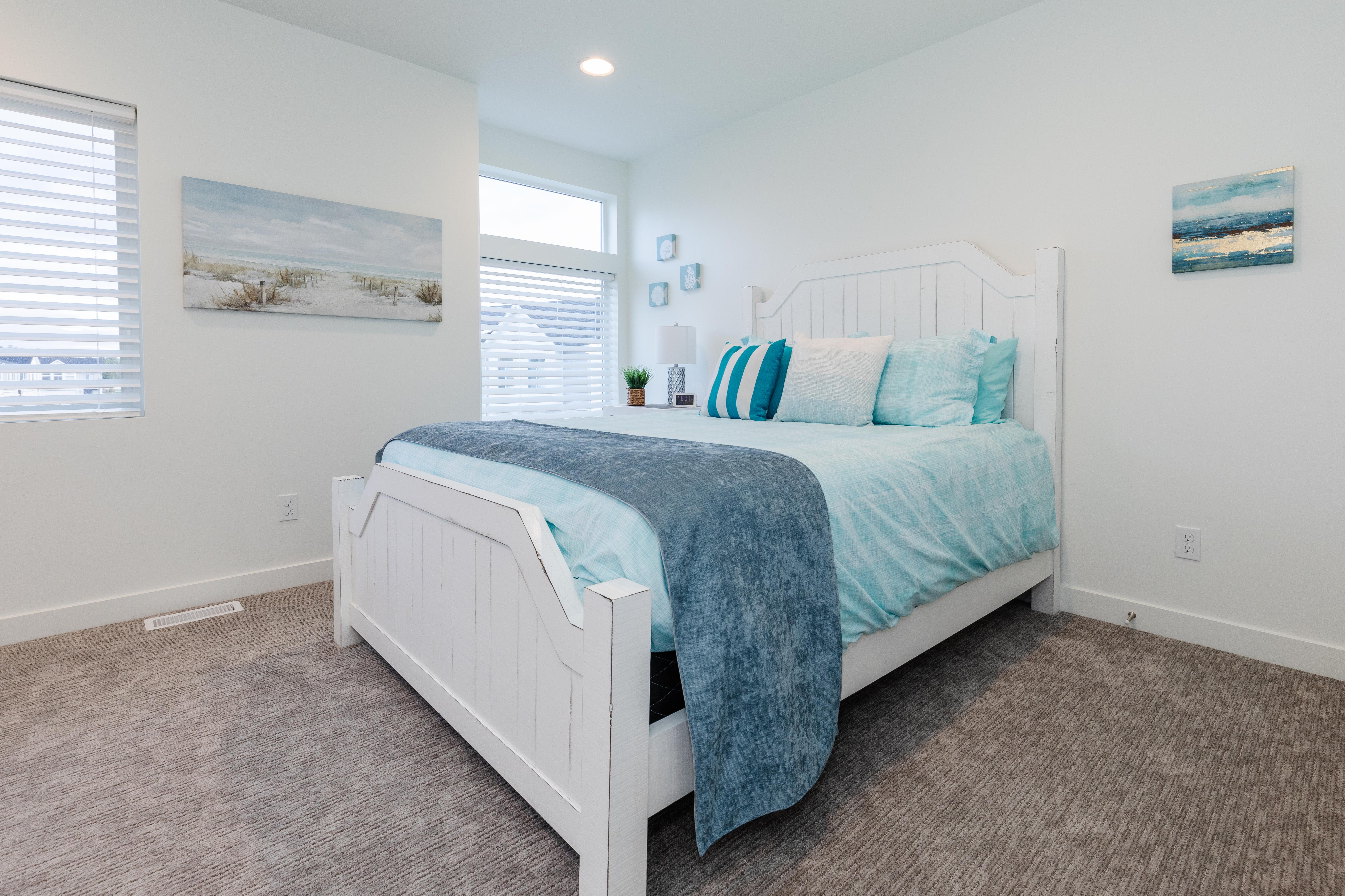 Bedroom with neutral-toned carpet flooring and white baseboards