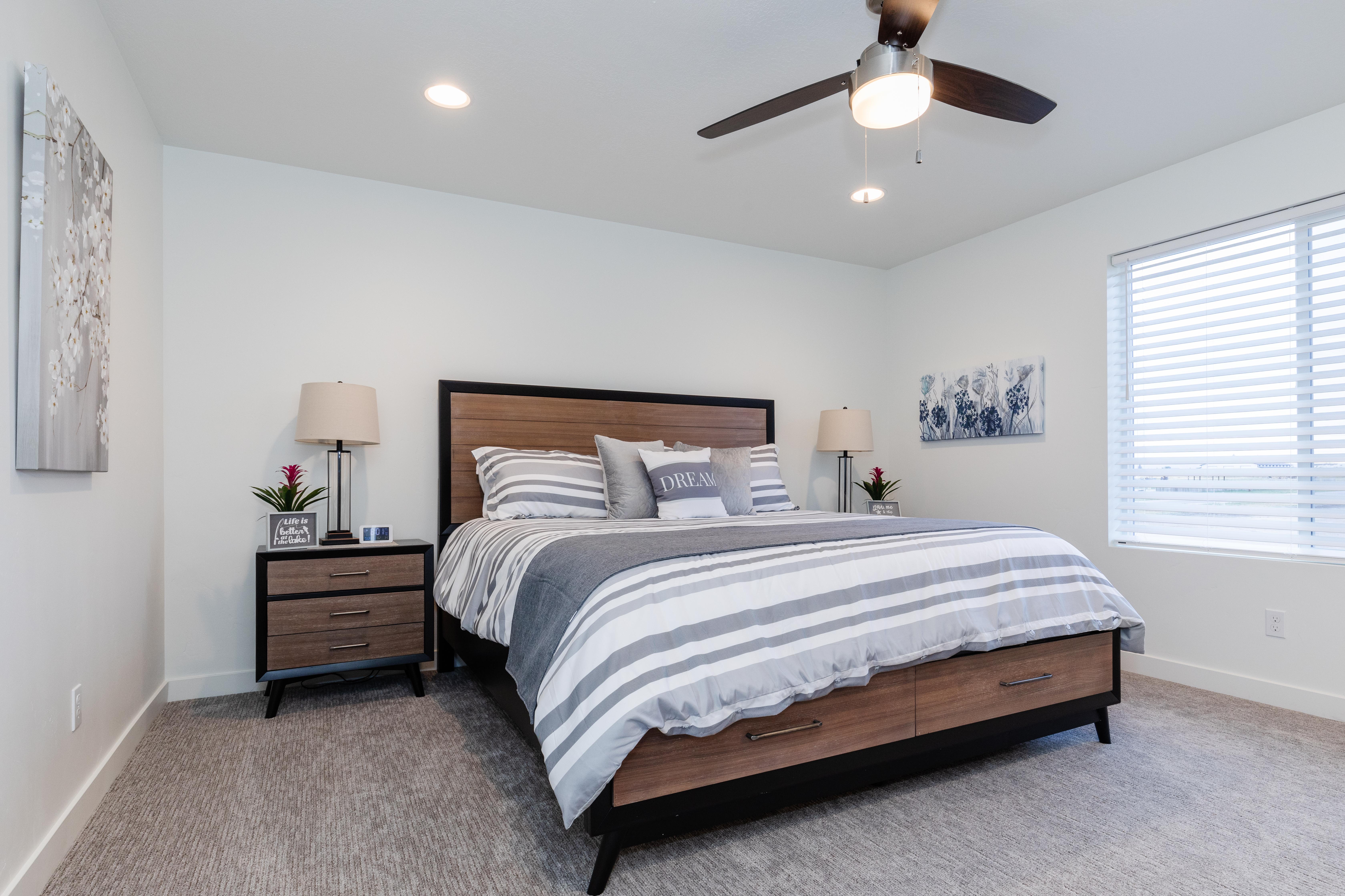 Carpeted room featuring a ceiling fan with integrated lighting, recessed lighting, and a large window with horizontal blinds