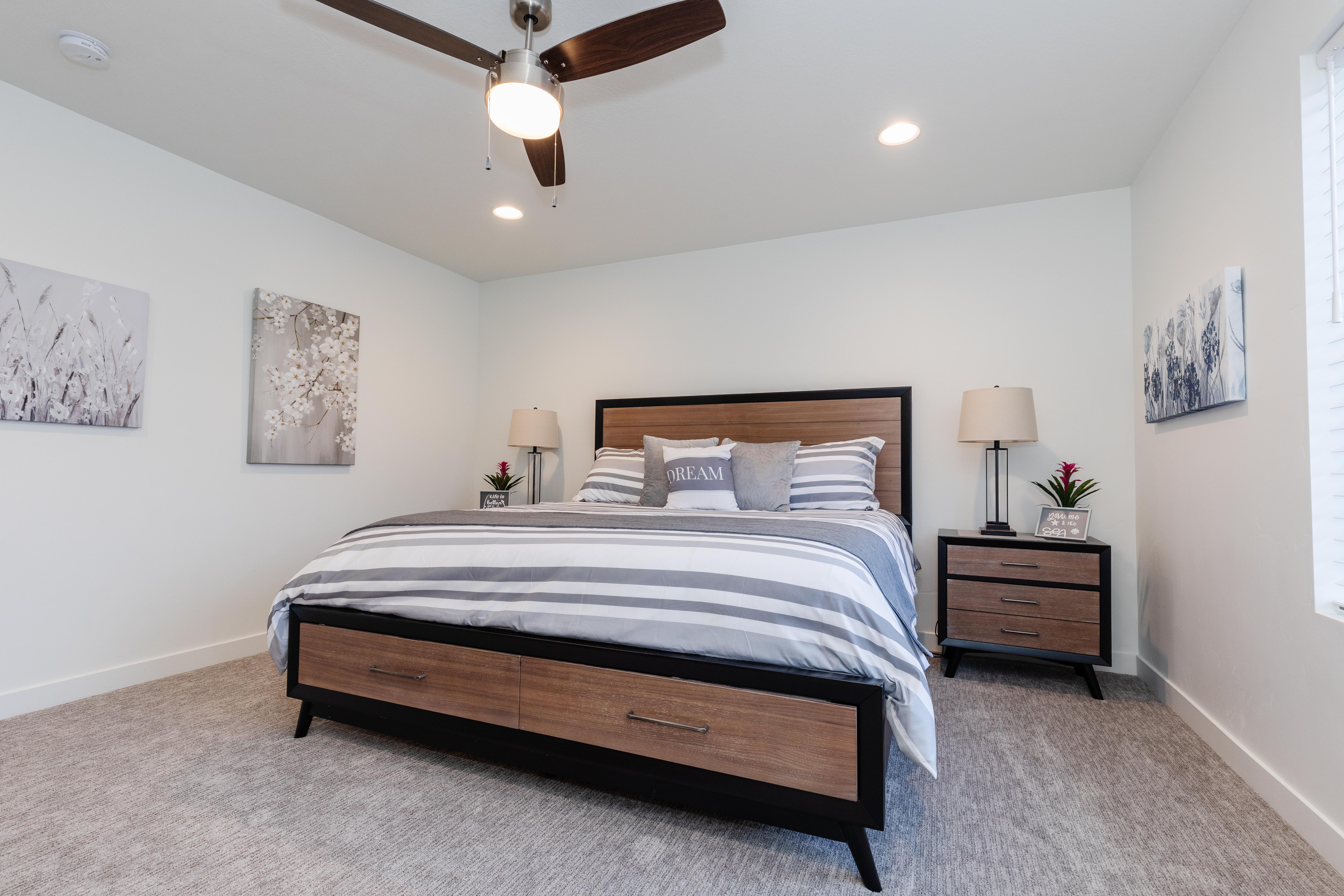 Spacious room featuring light-colored carpeting, recessed lighting, and a ceiling fan with integrated illumination