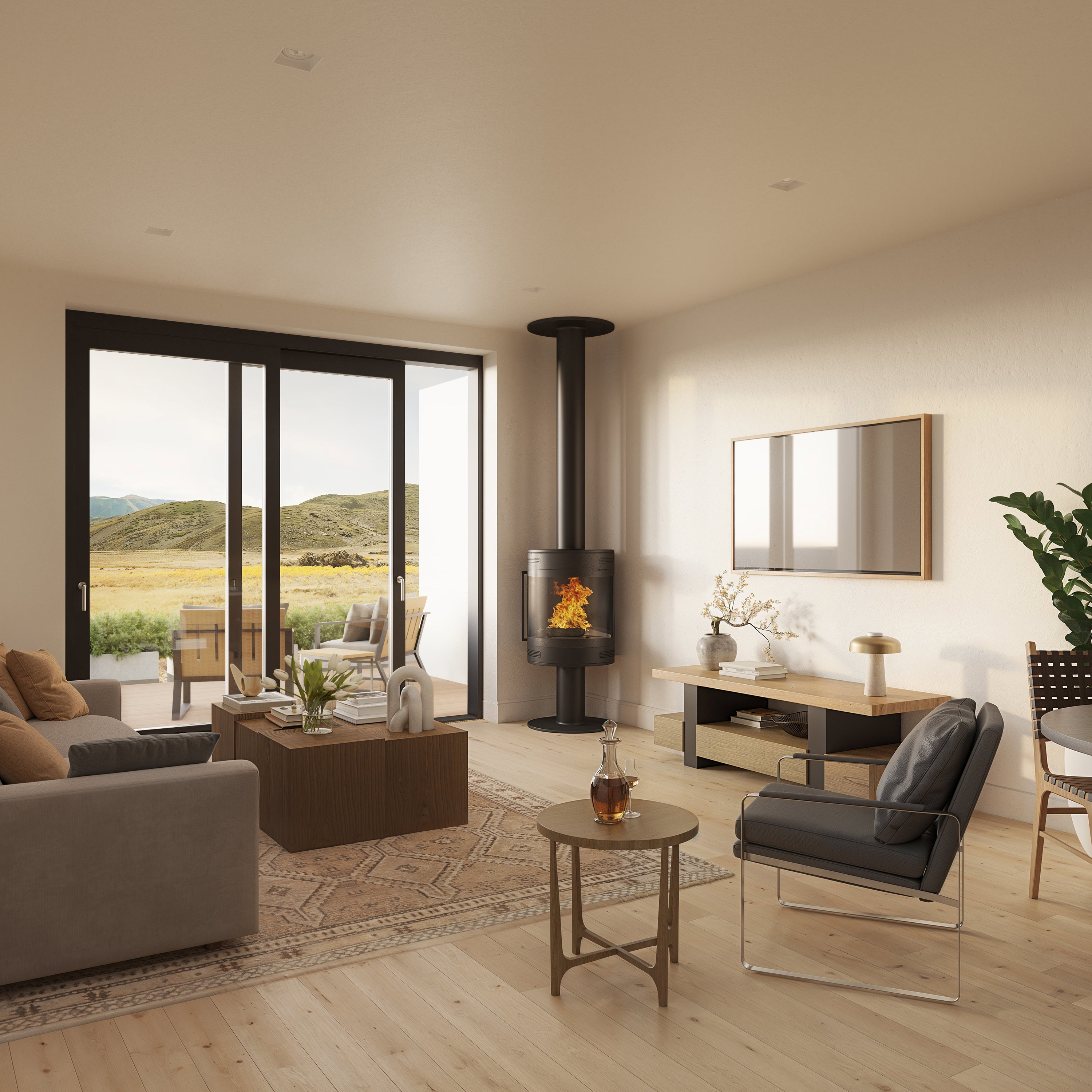 Spacious living area featuring light wood-finish flooring, a freestanding fireplace with a black flue, and large sliding glass doors opening to an outdoor patio