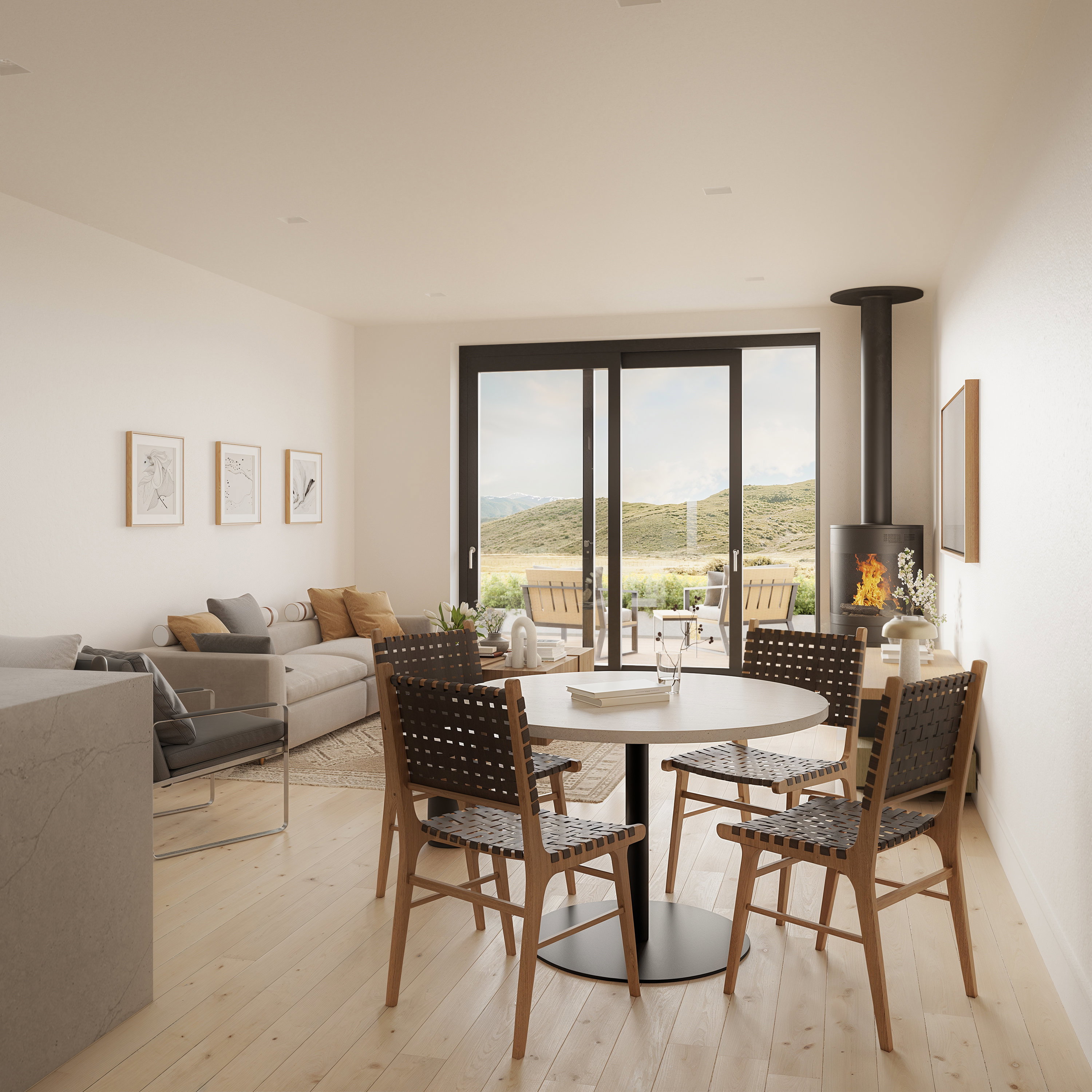 Open-concept living space featuring light wood-finish flooring, a freestanding fireplace with a black flue, and expansive sliding glass doors
