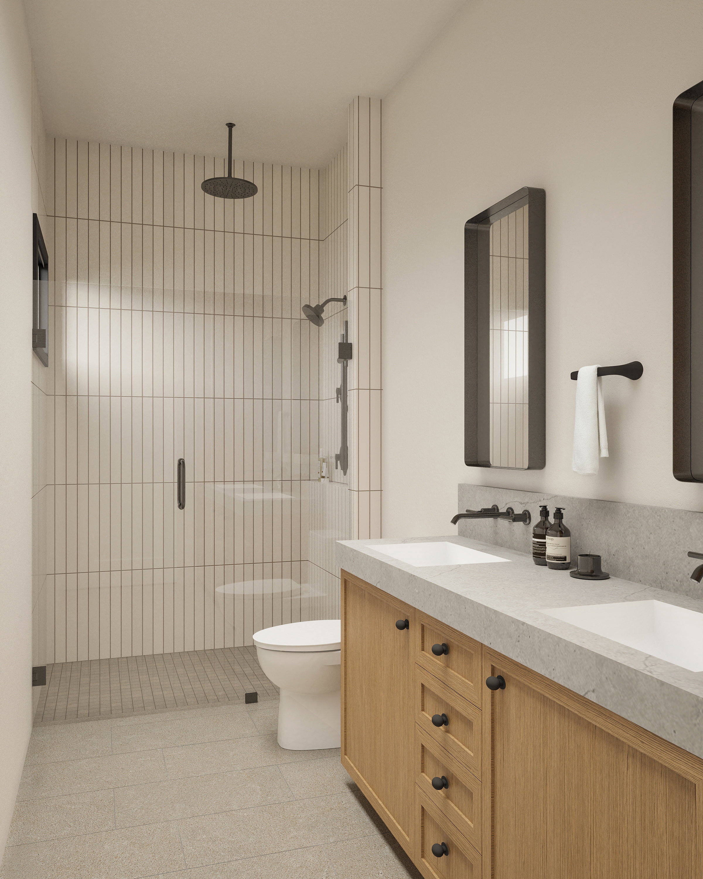 Contemporary bathroom featuring a spacious walk-in shower with a rainfall showerhead, dual vanity with undermount sinks, light wood-finish cabinetry, and a stone countertop
