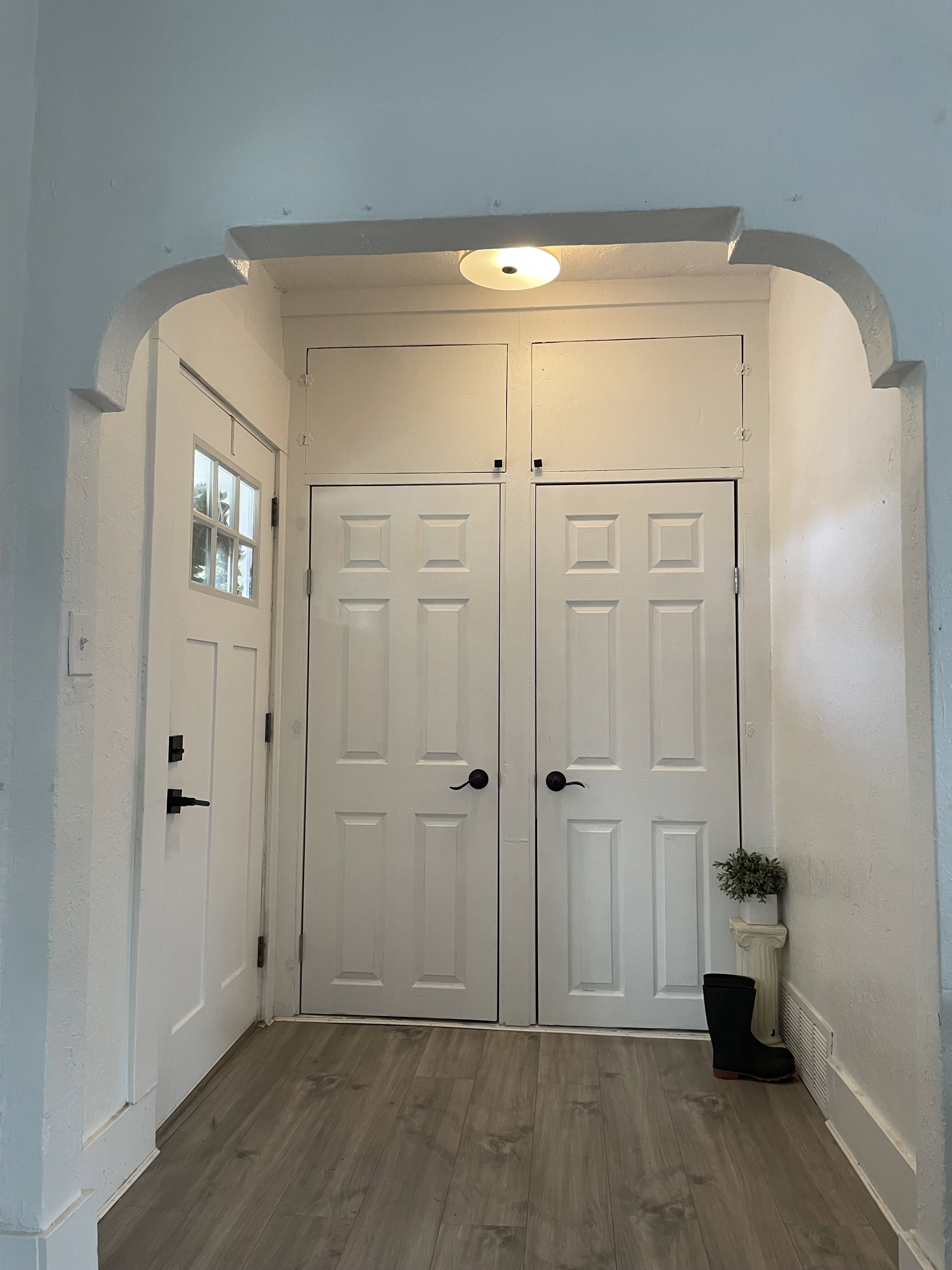 Entryway featuring wood-finish flooring and a white arched doorway