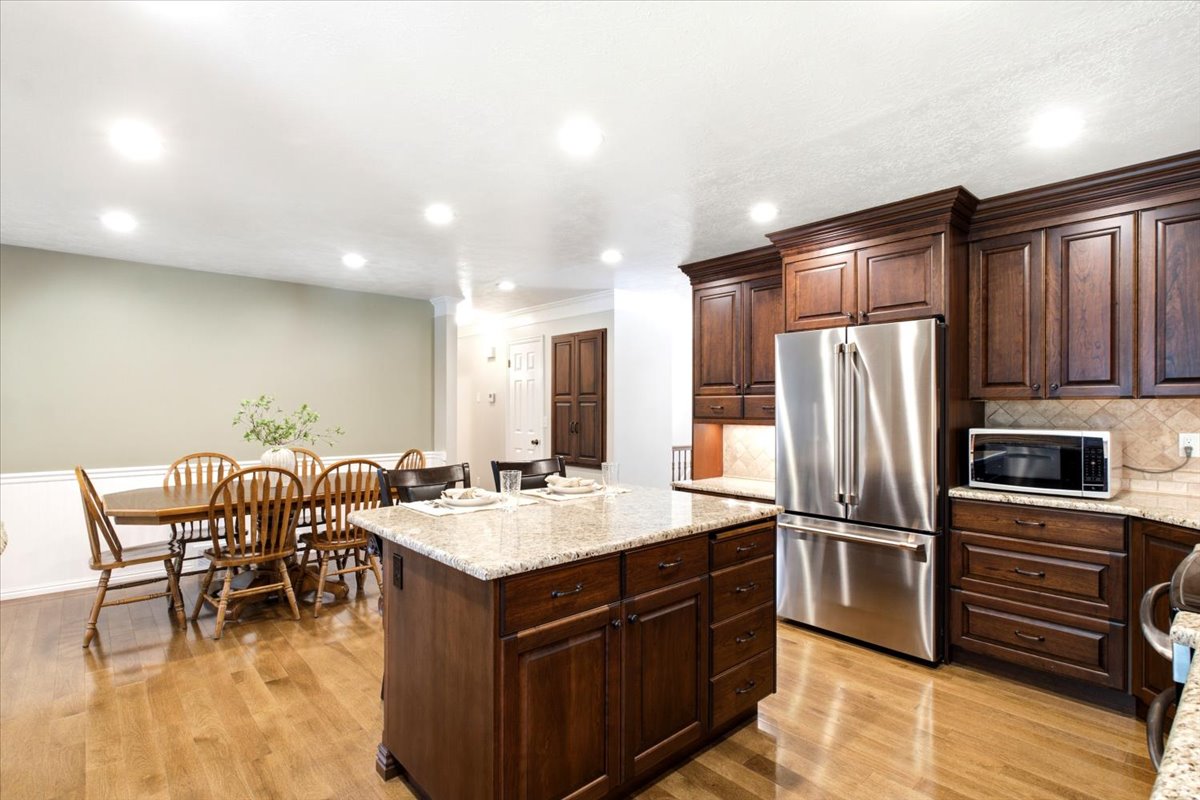 Large Island and dining area with extra LED recessed lights for a bright open feel, 2 built-in storage spaces in hall.