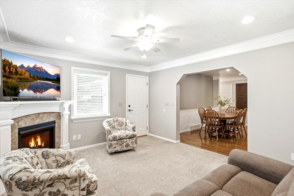 Family room with gas fireplace, recessed lighting and windows to invite plenty of light