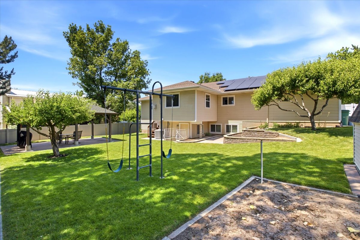 Sturdy built in swing set, garden area, fruit tress, planter boxes, gazebo, with full sprinklers and fully fenced. Other features include Solar Panels with battery back up to power entire home and RV parking