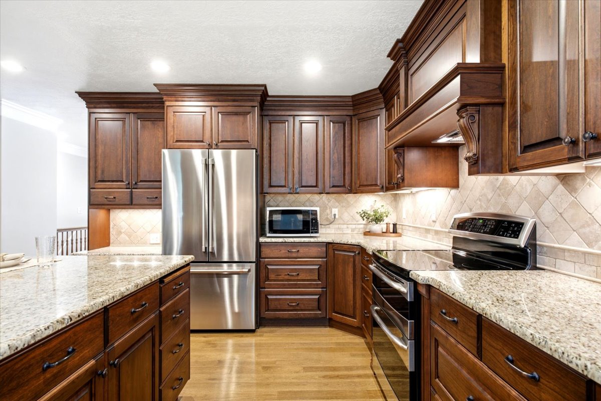 Beautiful cabinetry and granite countertops. Range hood vented to outside. Updated oven and dishwasher. Refrigerator is excluded