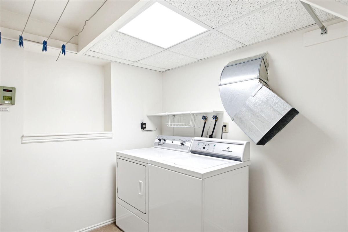 Bright open laundry room with functional clothes lines and laundry shoot