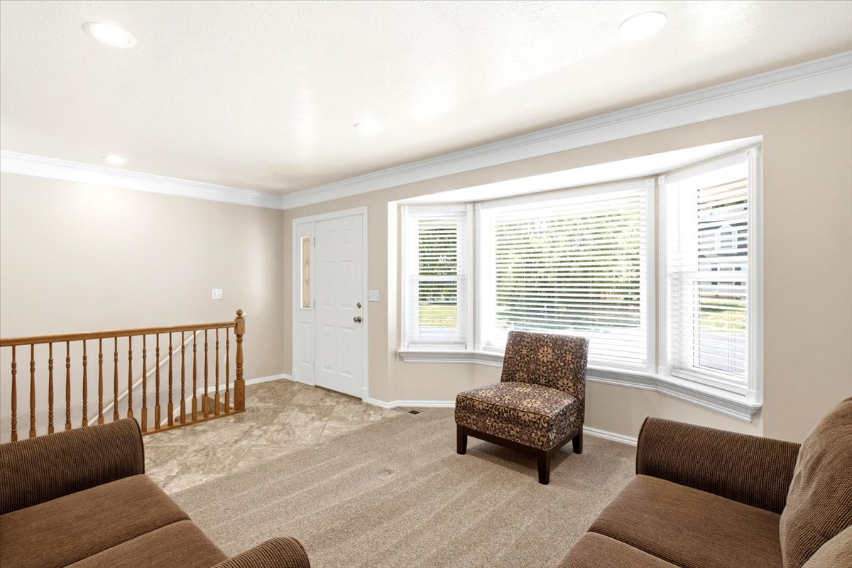 Formal living room with recessed lighting, and bay window. Entry was with convenient access to basement