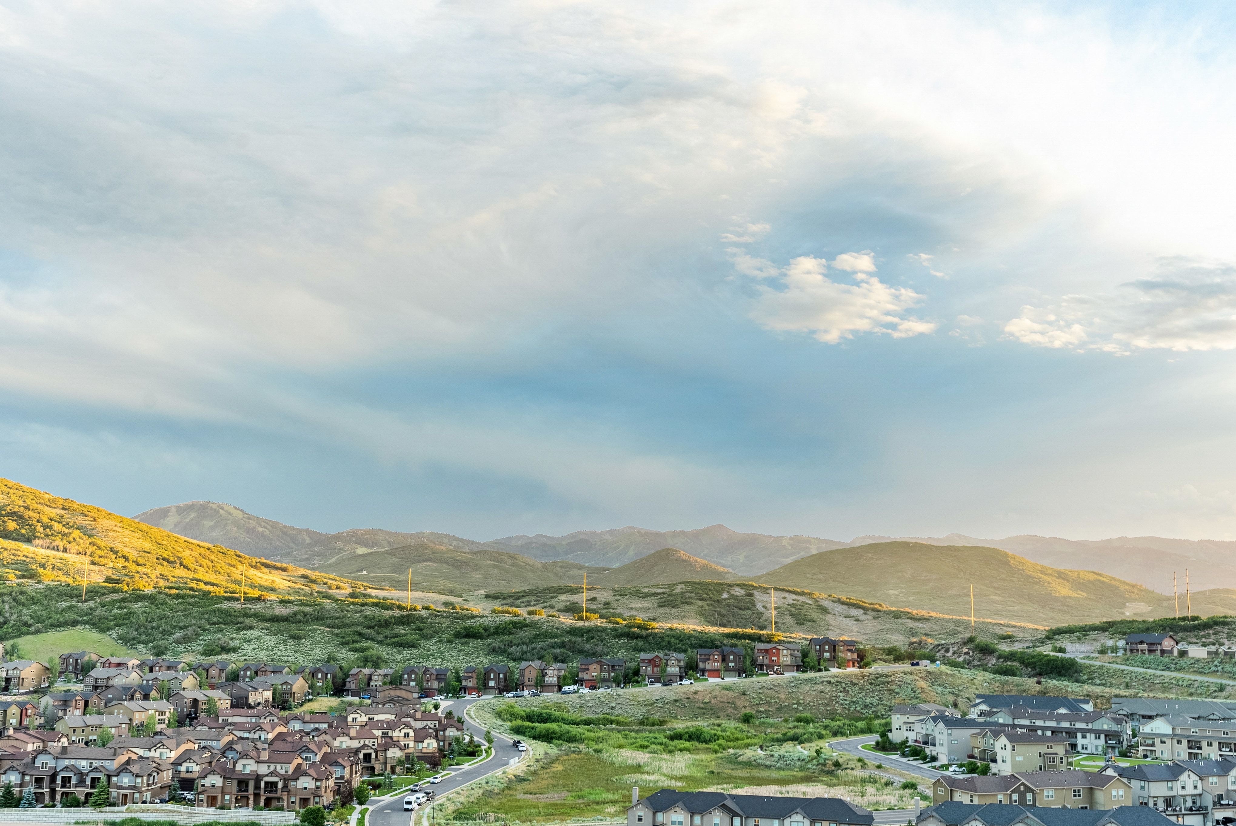 Expansive neighborhood featuring numerous residential properties nestled within a mountainous landscape