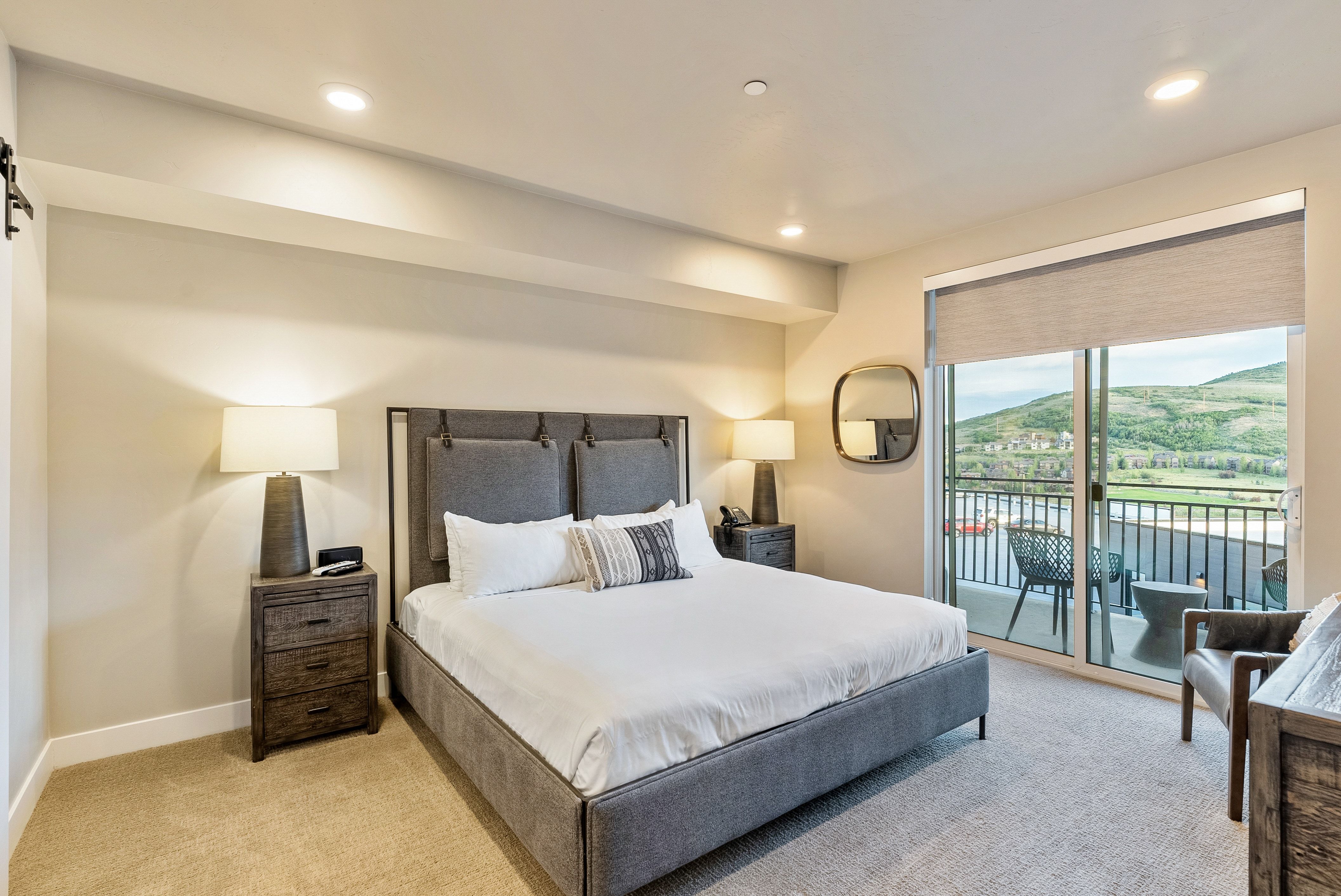 Bedroom featuring a sliding glass door to a private balcony, recessed lighting, and carpet flooring