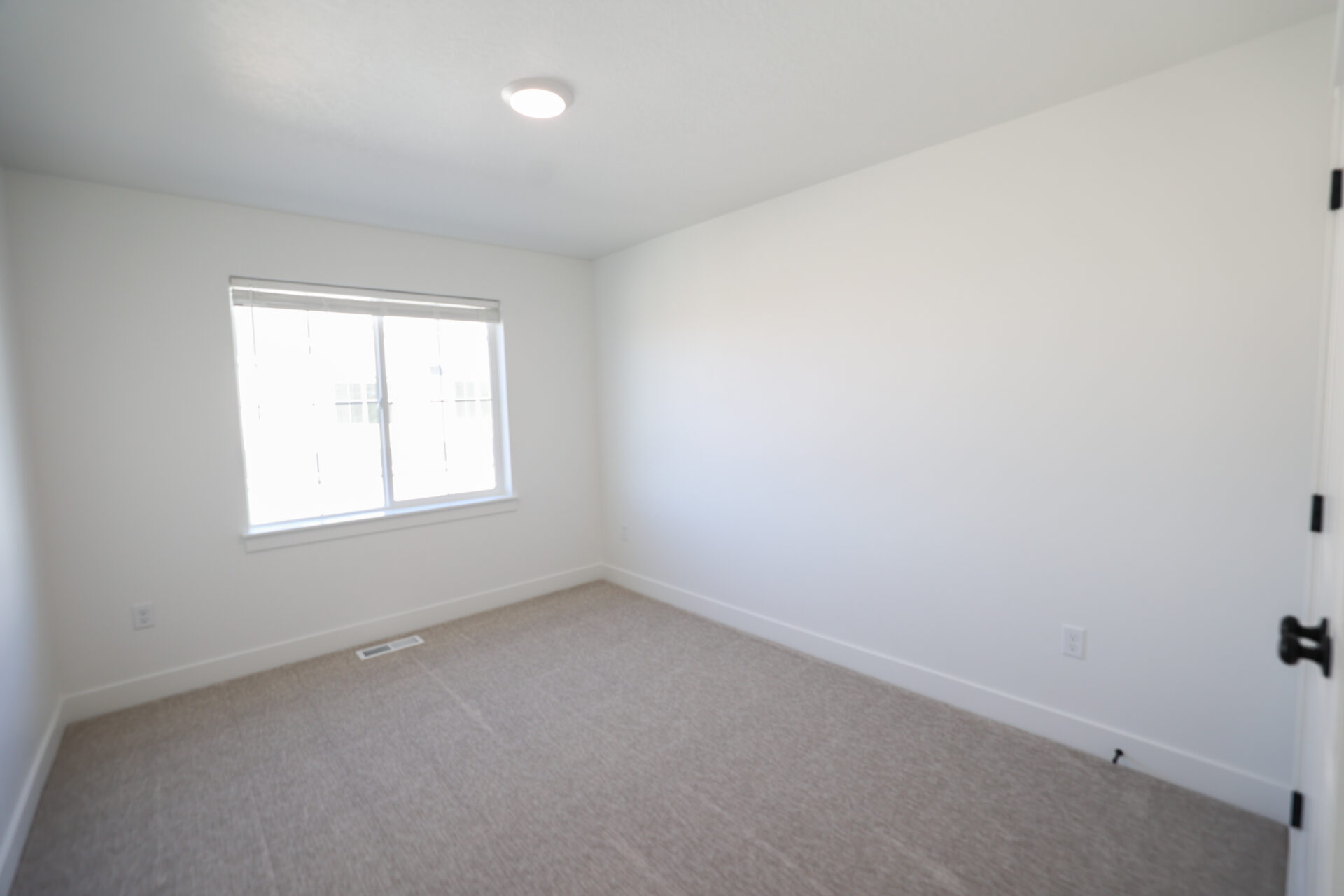 Neutral tone carpeting and white walls in a bright interior space