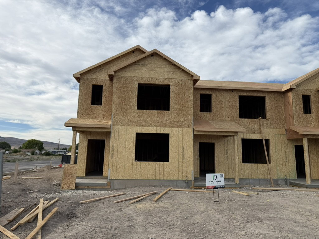 New construction townhome framing showcasing two stories and multiple window openings