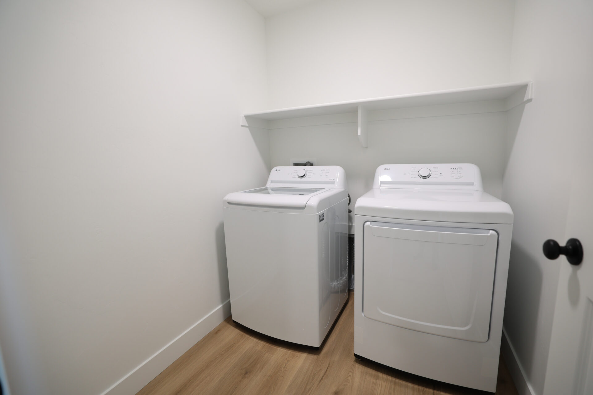Dedicated laundry area featuring a white top-load washer and a white front-load dryer