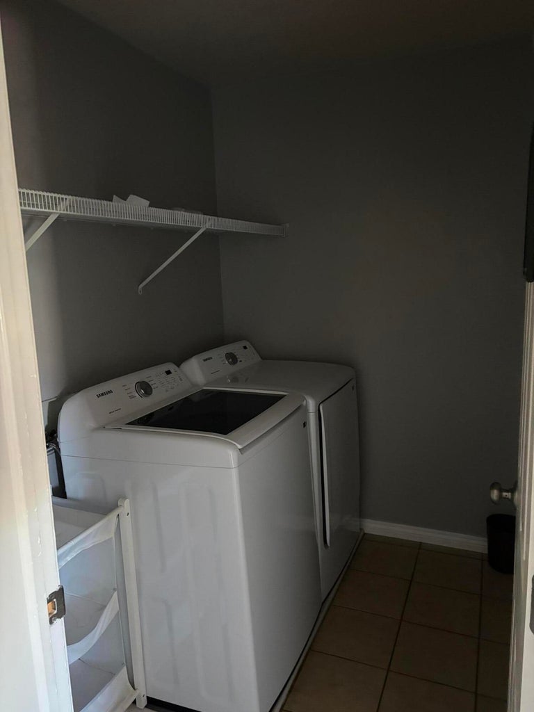 Dedicated laundry area featuring ceramic tile flooring