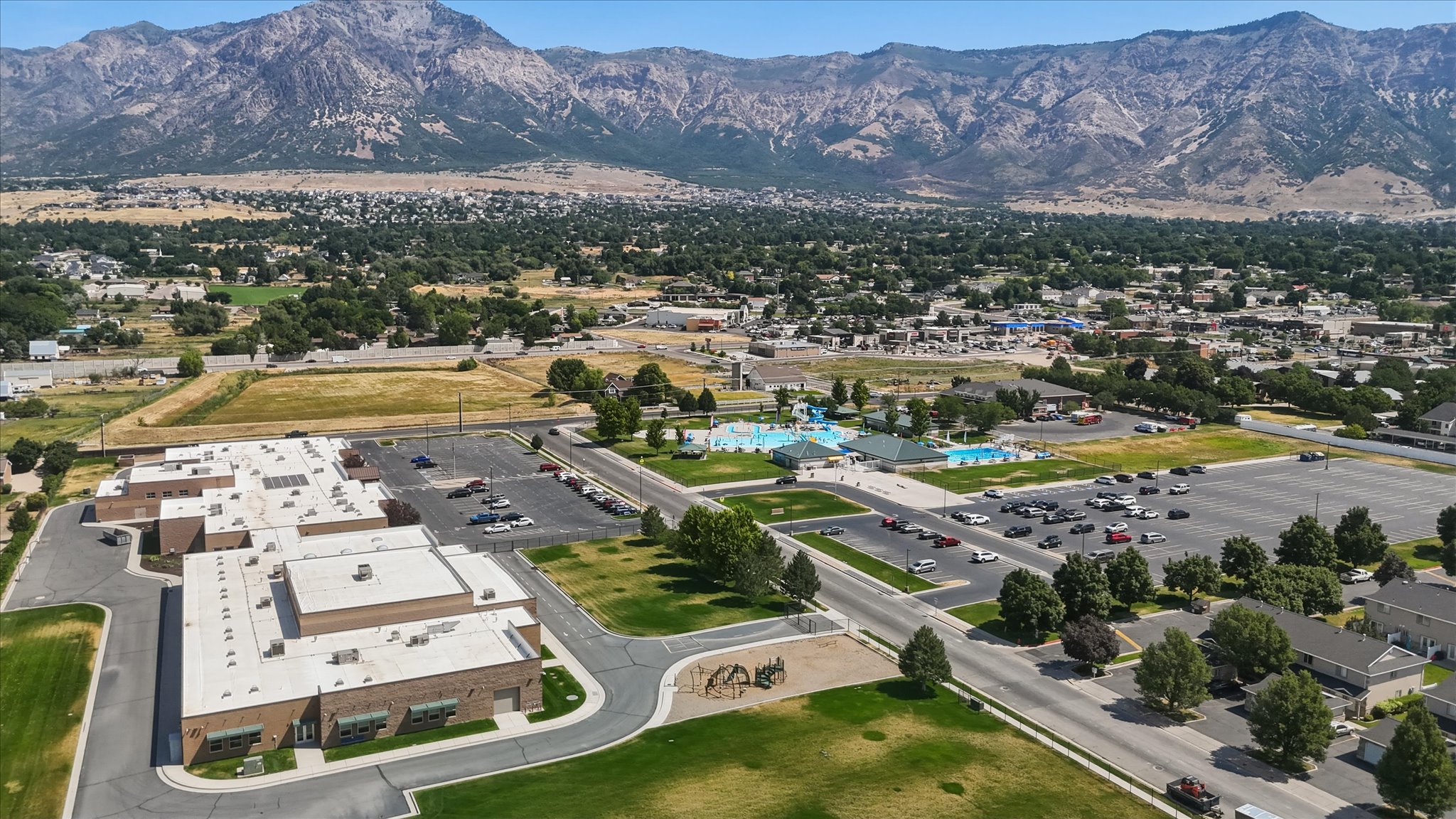 Expansive aerial capturing a community with mountainous backdrop