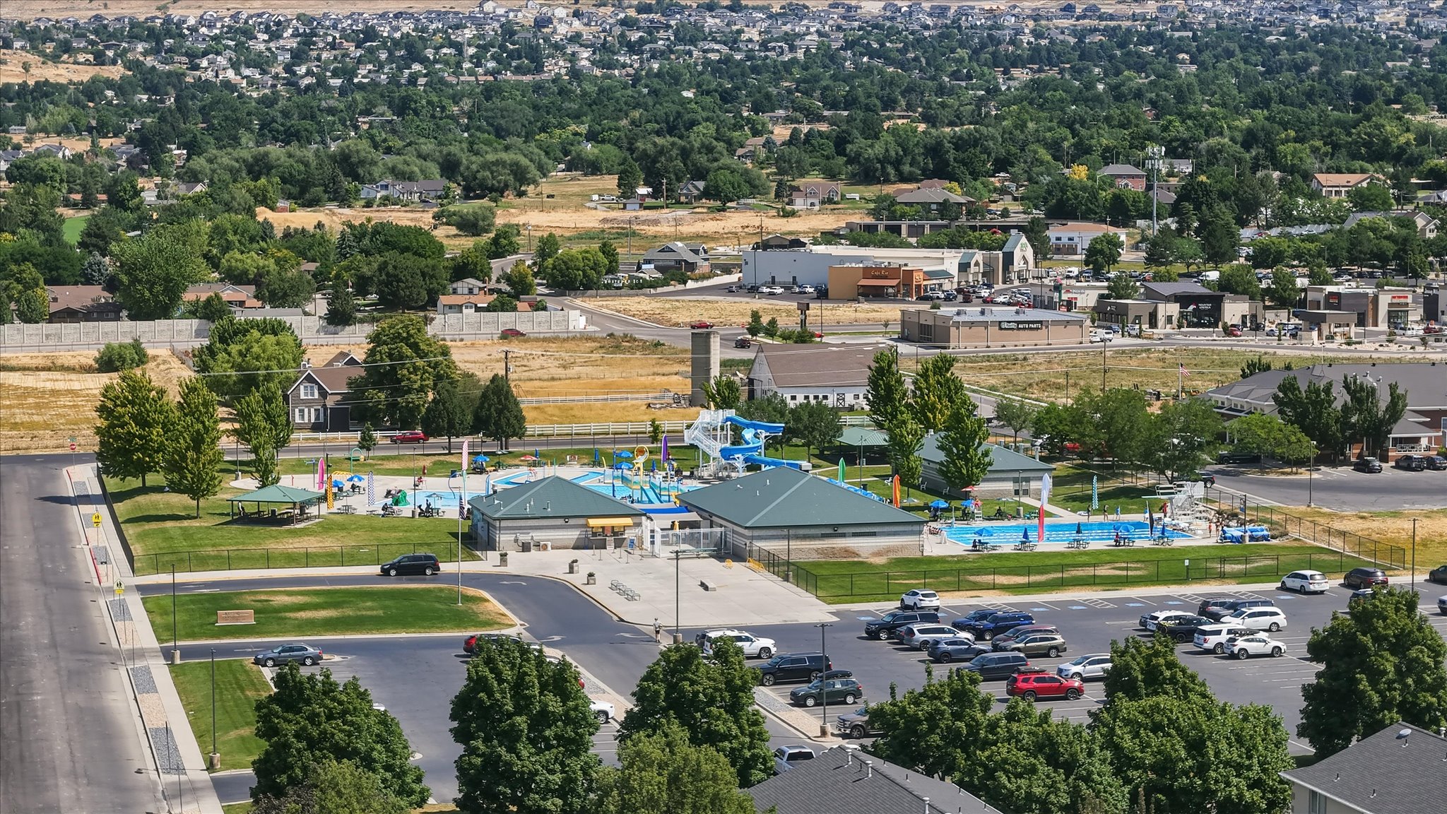 Aquatic center featuring multiple pools, water slides, and recreational areas