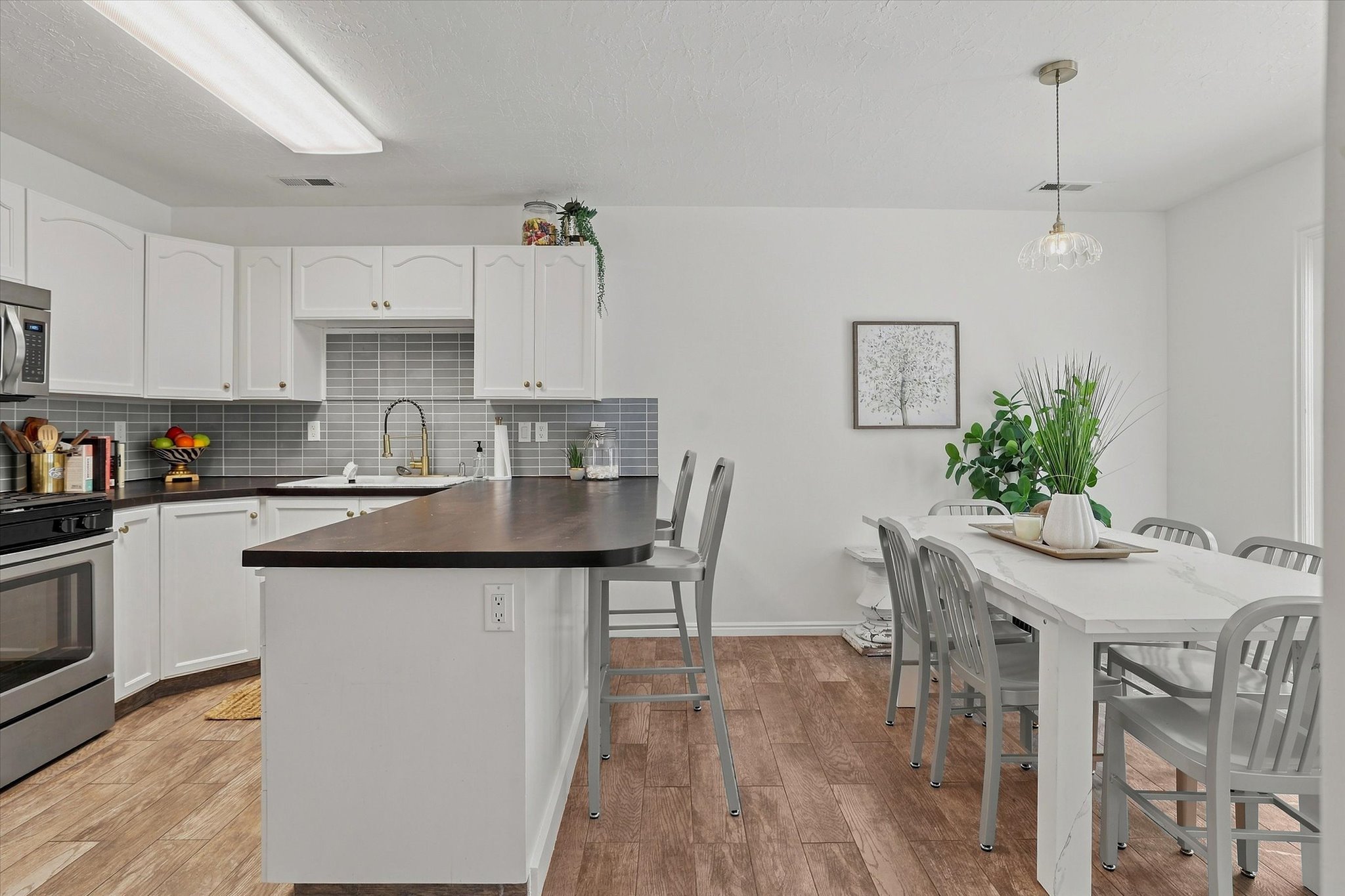 Open concept kitchen and dining area featuring wood-finish flooring