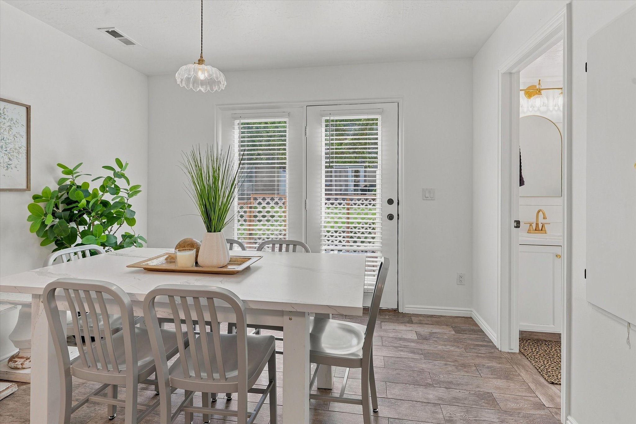 Dining area featuring wood-finish flooring and a white dining table