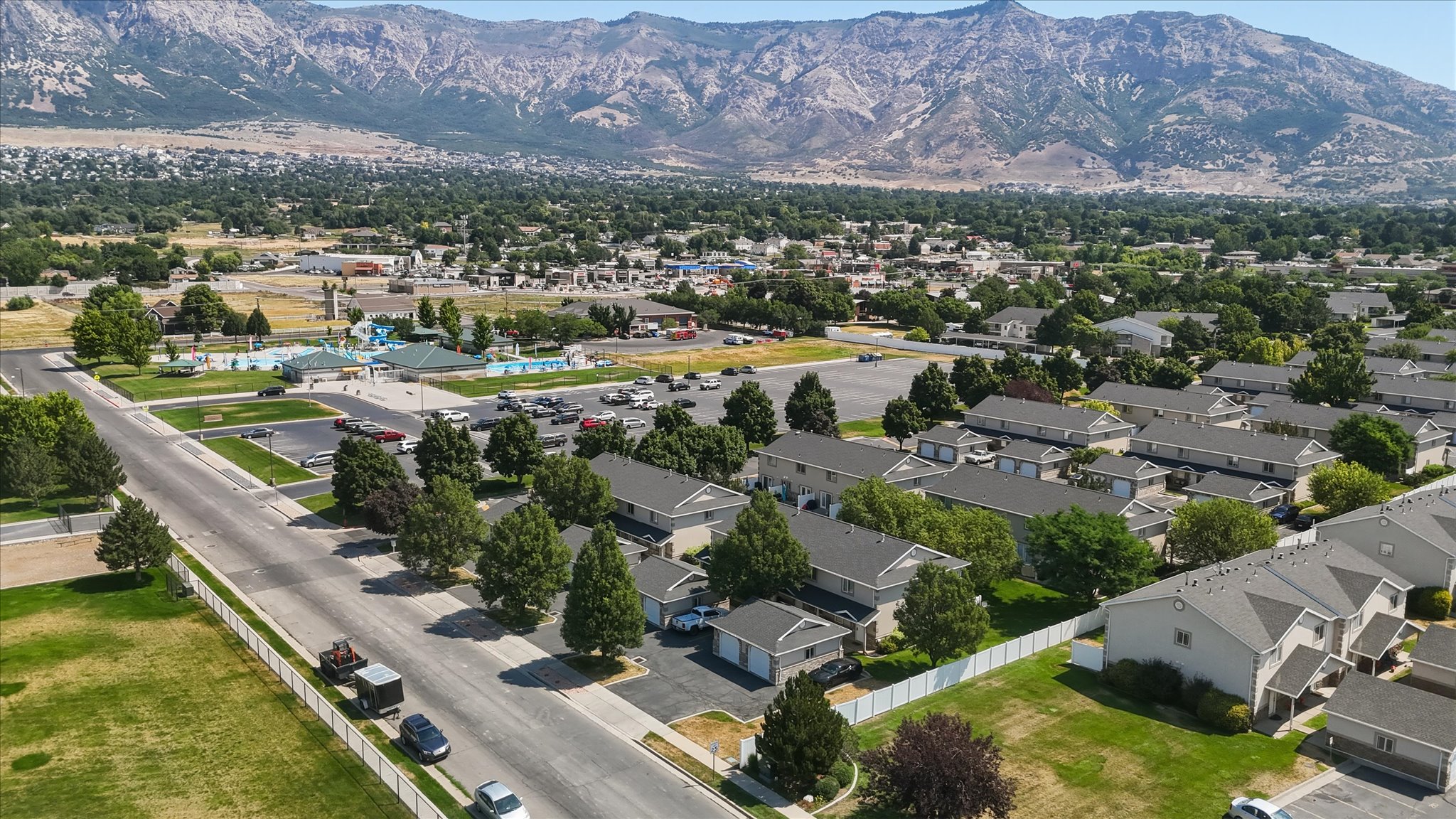 Townhome community featuring neutral-toned siding, dark roofing, and attached garages