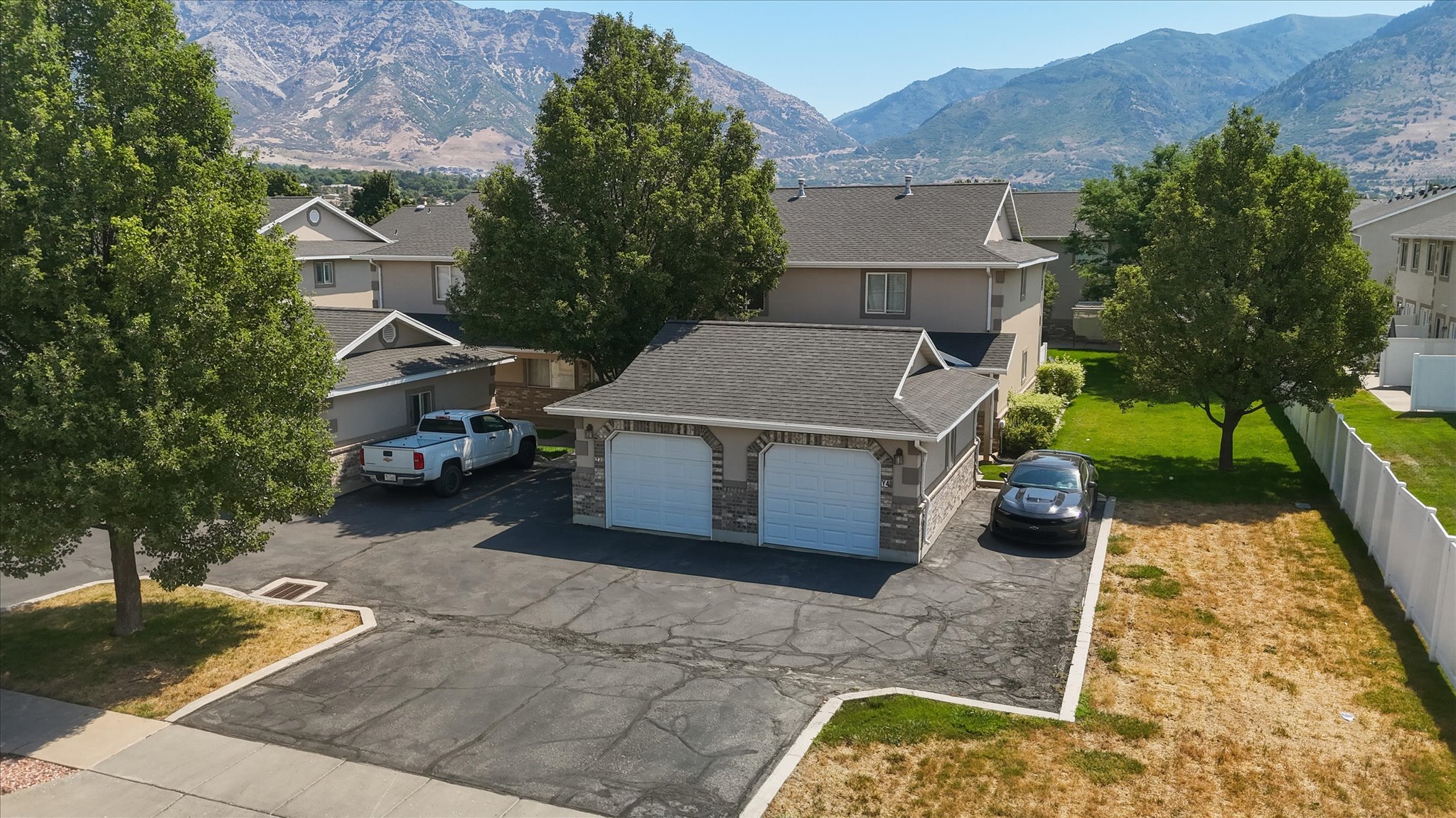 Two-story residence featuring a two-car attached garage with stone veneer accents and white garage doors