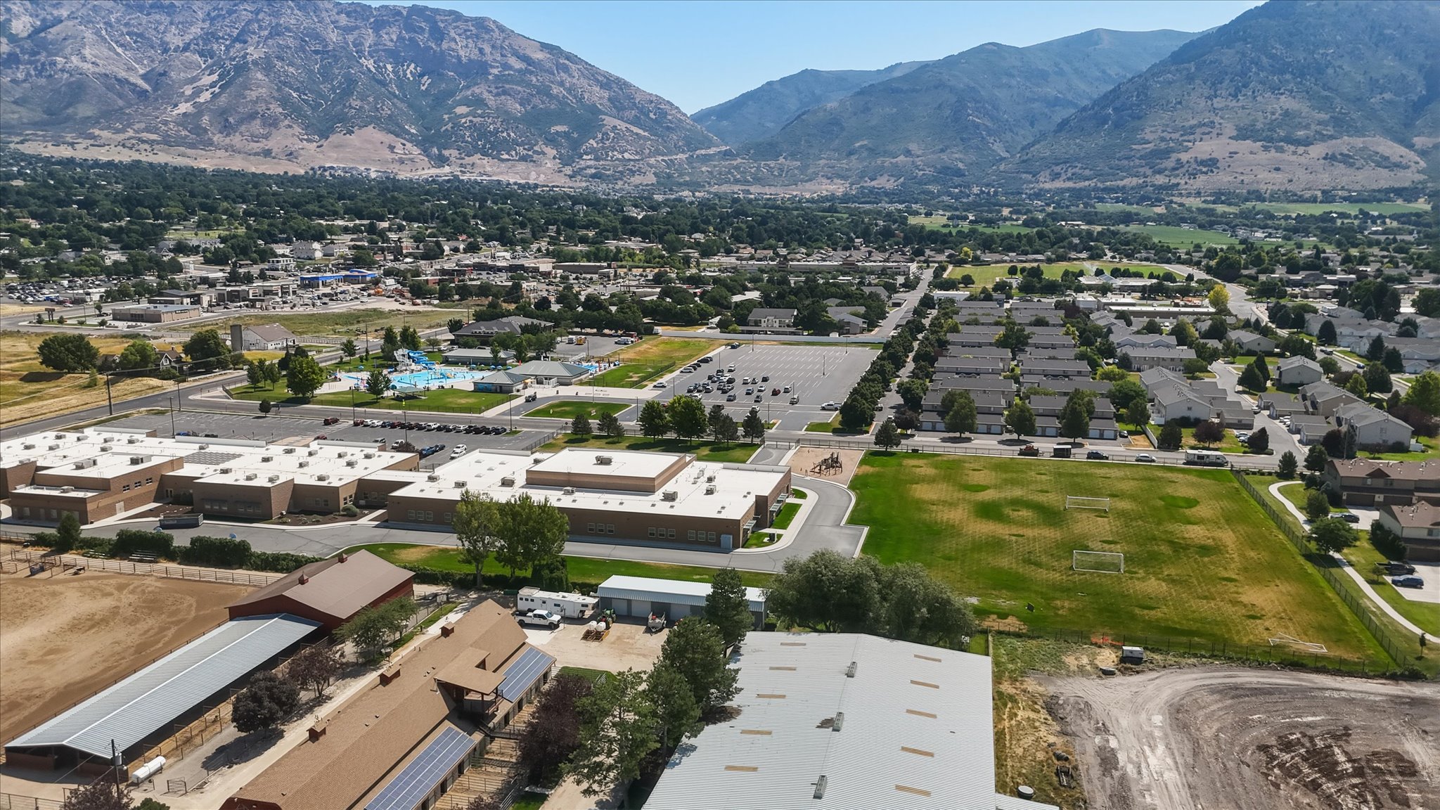 Expansive aerial perspective showcasing a residential community with distant mountain ranges