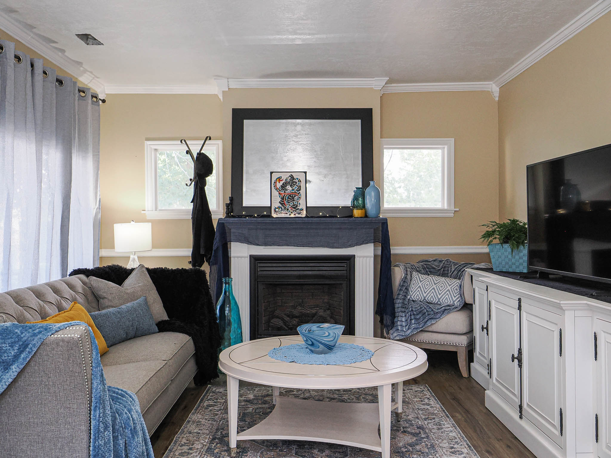 Living area featuring crown molding, neutral wall tones, and wood-finish flooring