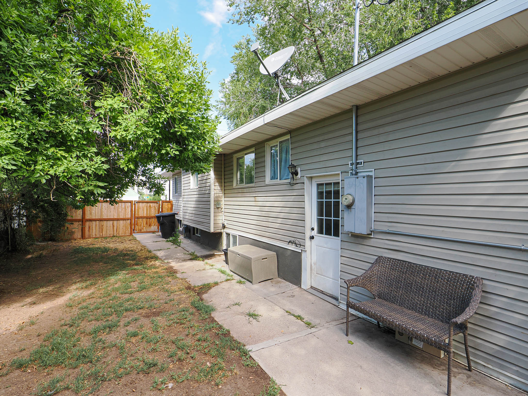 Exterior featuring horizontal siding, multiple windows, and a private rear entry door