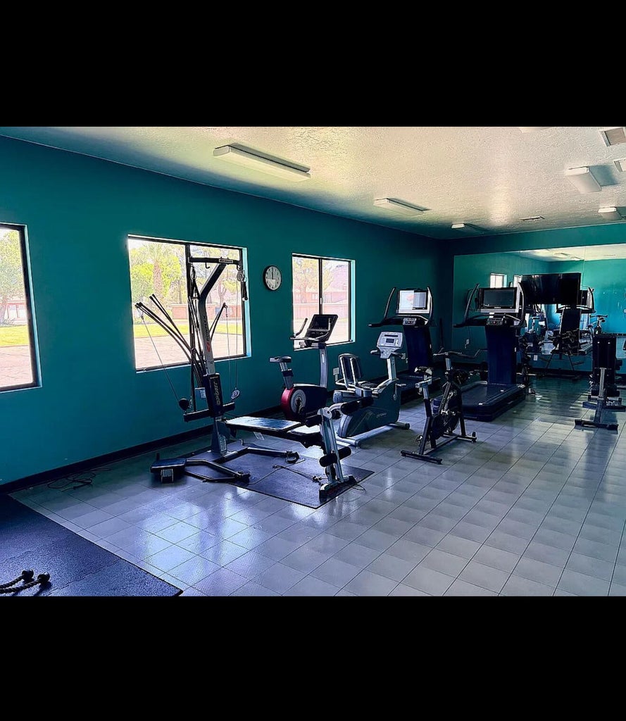 Fitness center featuring blue tiled flooring and multiple large windows