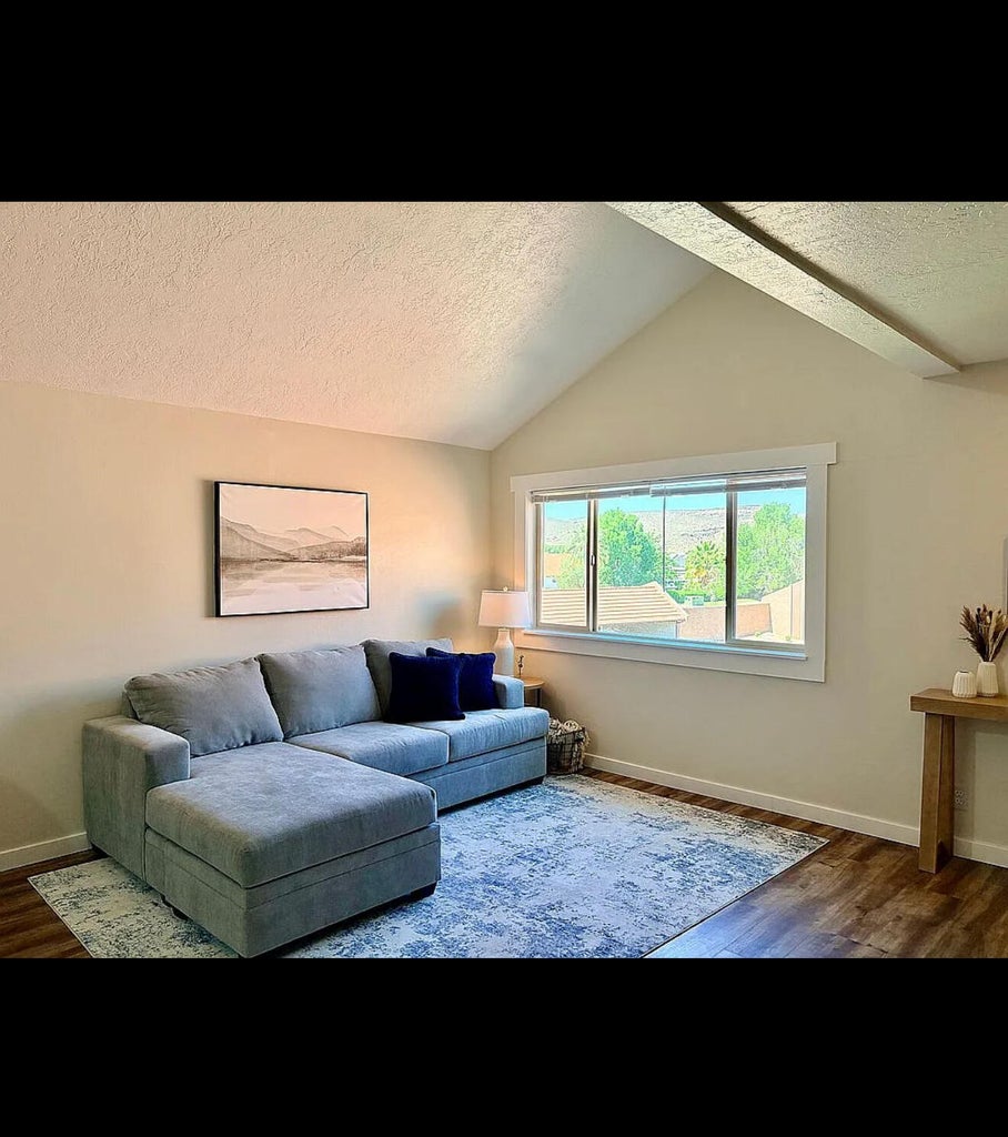 Vaulted ceilings above a large window providing outdoor scenery