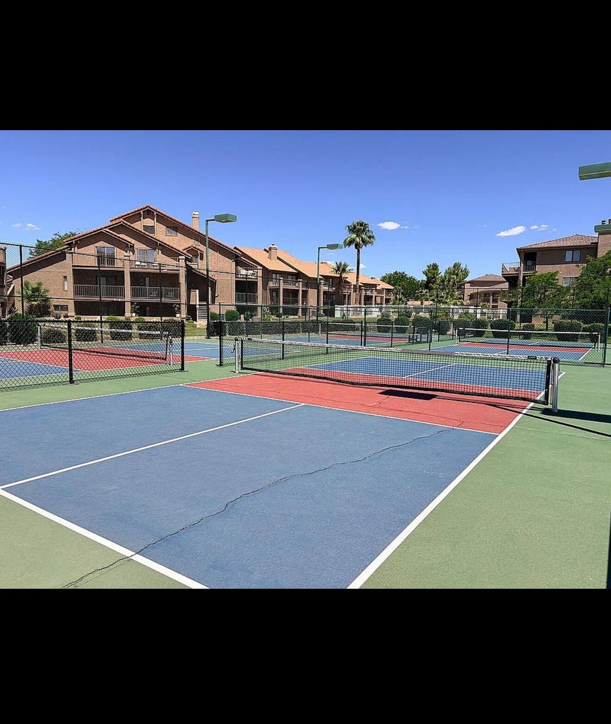 Multiple outdoor sport courts featuring blue, red, and green surfacing