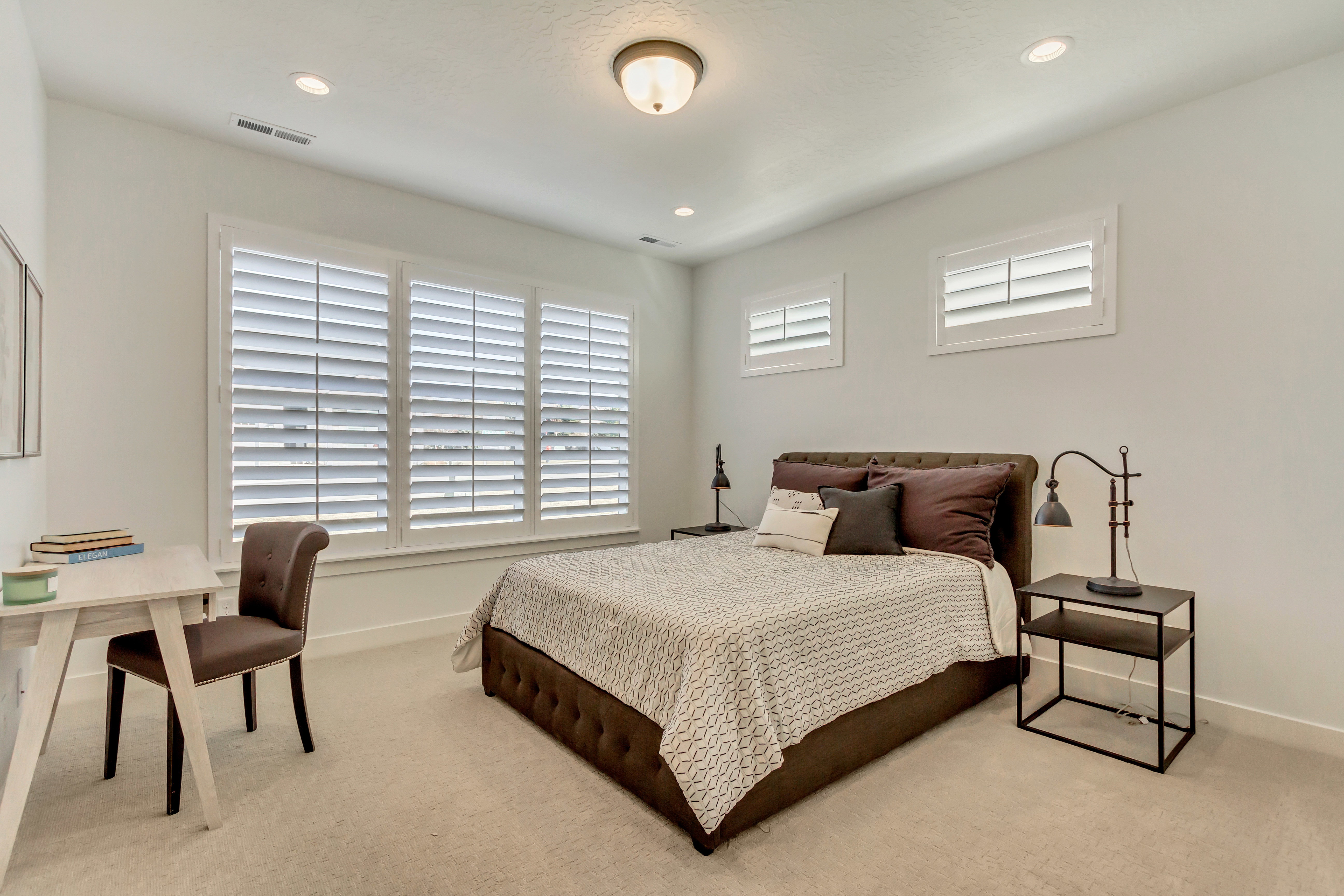 Bright interior featuring multiple windows with louvered shutters, recessed lighting, and a neutral wall color